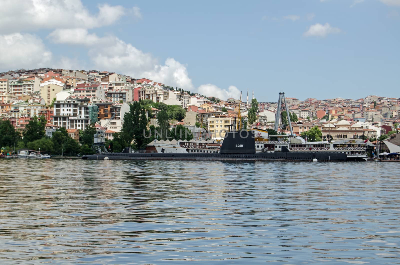 ISTANBUL, TURKEY - JUNE 5, 2016:  View looking north across the Golden Horn towards the Rami M Koc Museum of transport on a sunny afternoon in Istanbul.  There's a World War II submarine together with other ships on display.