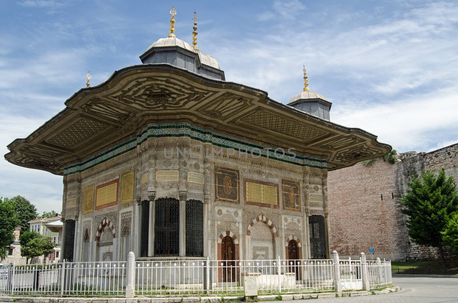 Exterior of the public fountain constructed in 1728 for Sultan Ahmed III just outside the gates to the famous Topkapi Palace in Istanbul, Turkey.  Designed in the Ottoman 'tulip' style it has basins and flowing water for people to use in the middle of this hot and busy city.  