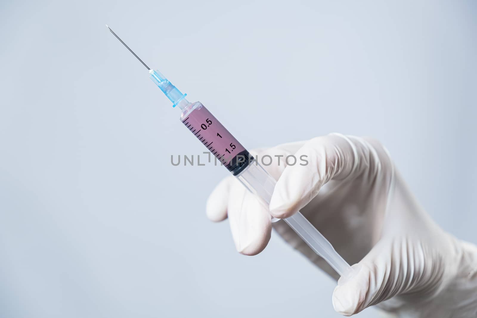 Injection ready for application in doctor's hand. by photoboyko