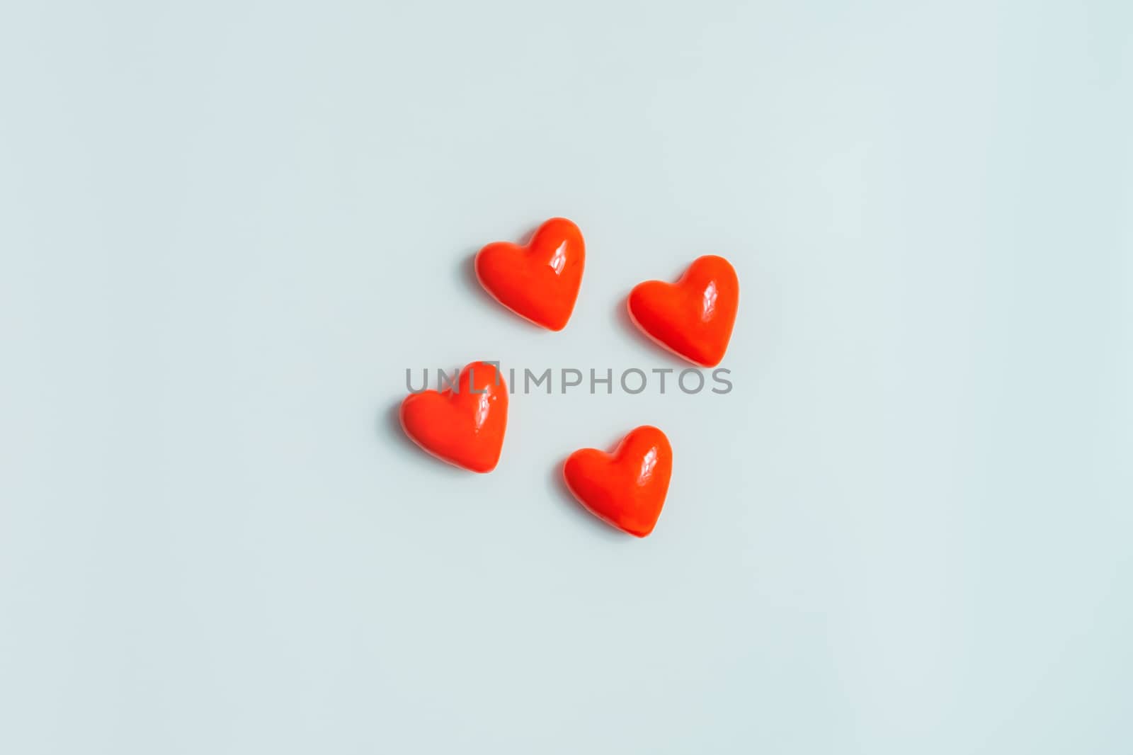 Close up view of four  hearts on a gray background. by photoboyko