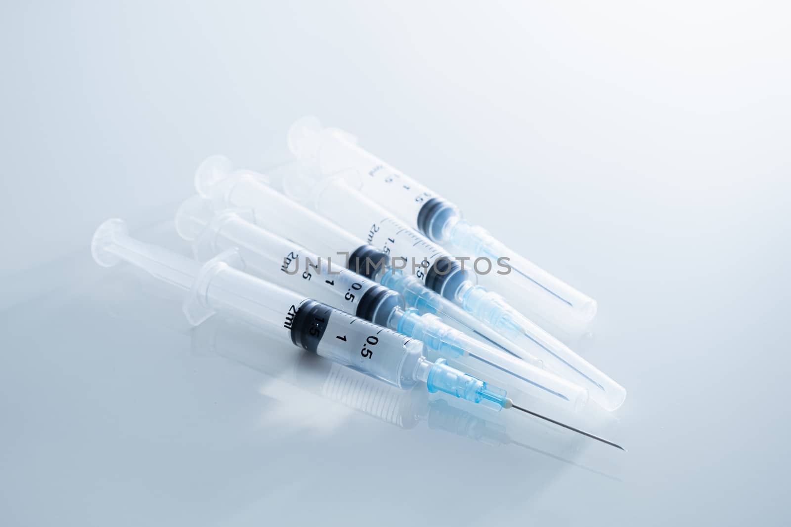 Syringes in clean medical background. by photoboyko