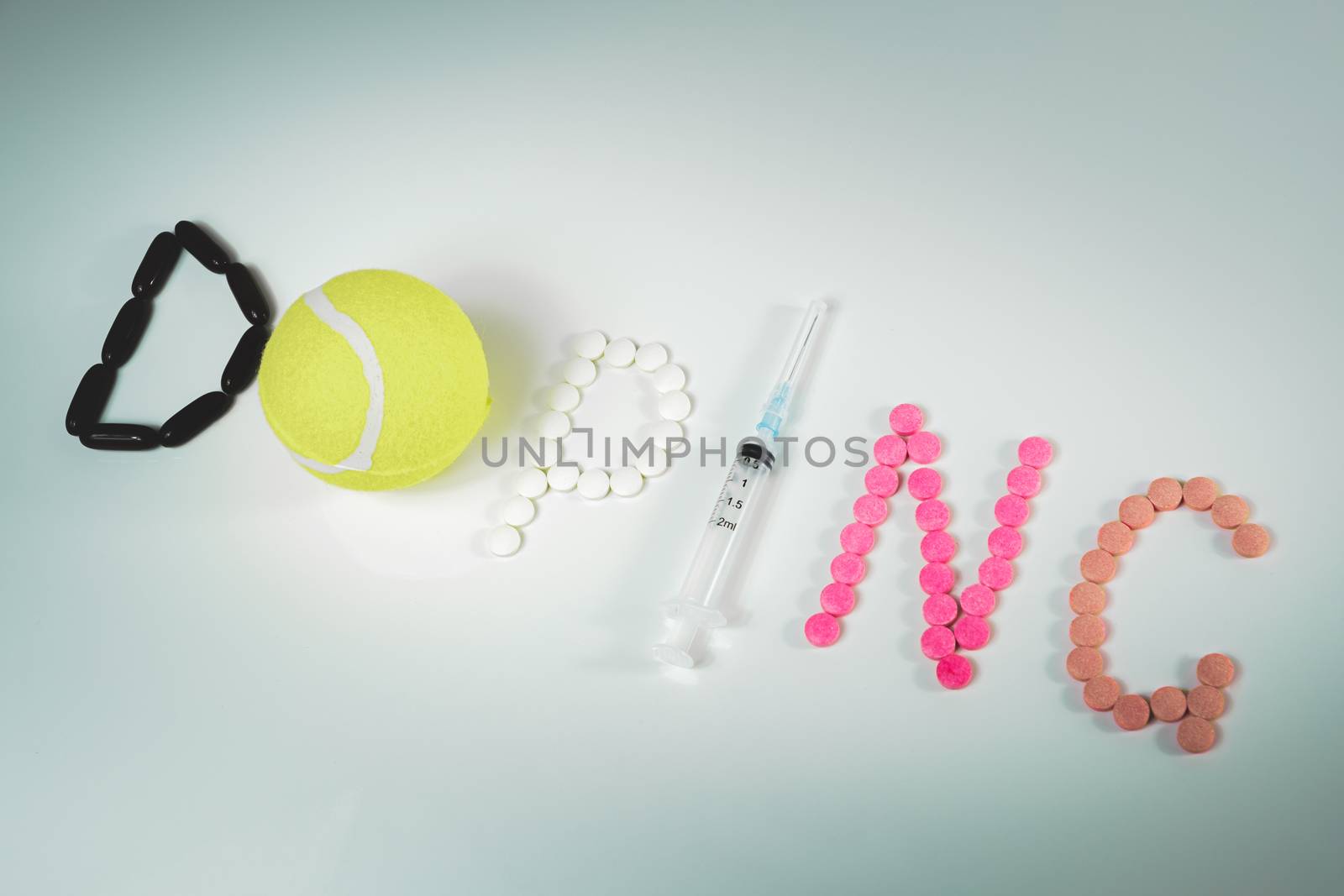 "Doping" word made of pills, tablets, syringe and a tennis ball. by photoboyko