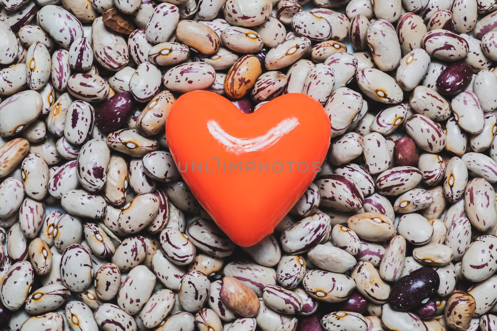 Heart shape on a heap of beans. Food for the heart's health, healthy eating concept.