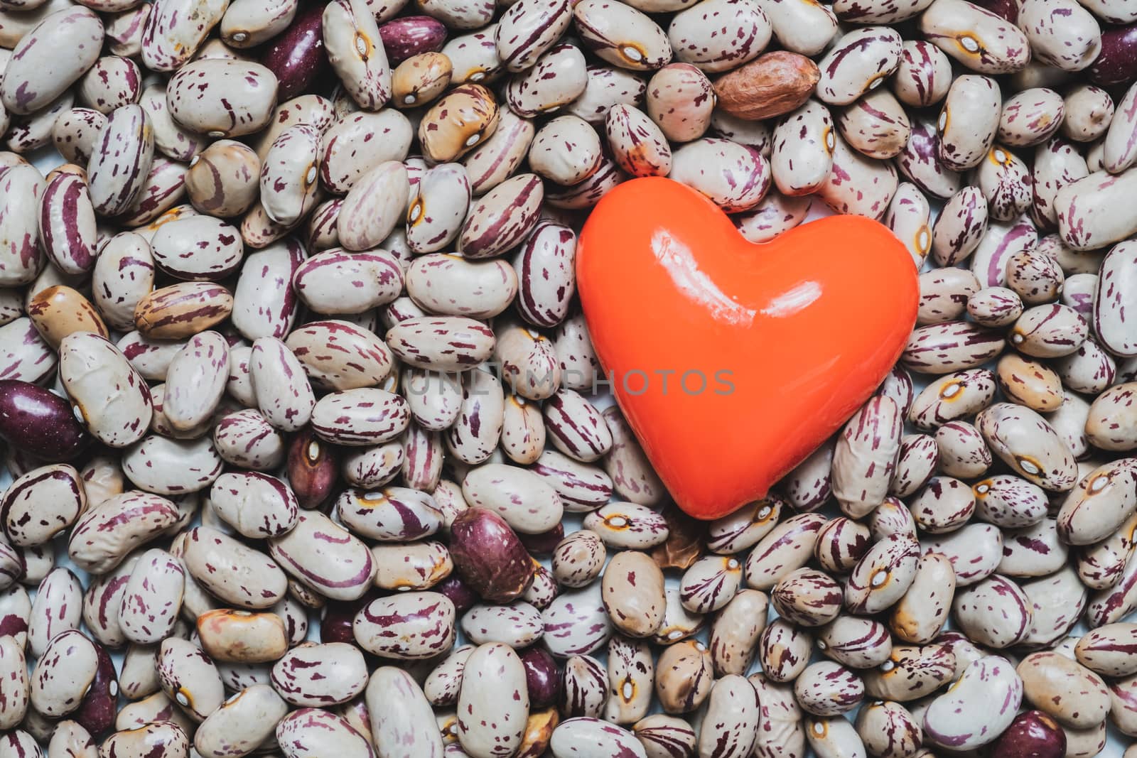 Heart shape on a heap of beans. Food for the heart's health, healthy eating concept.