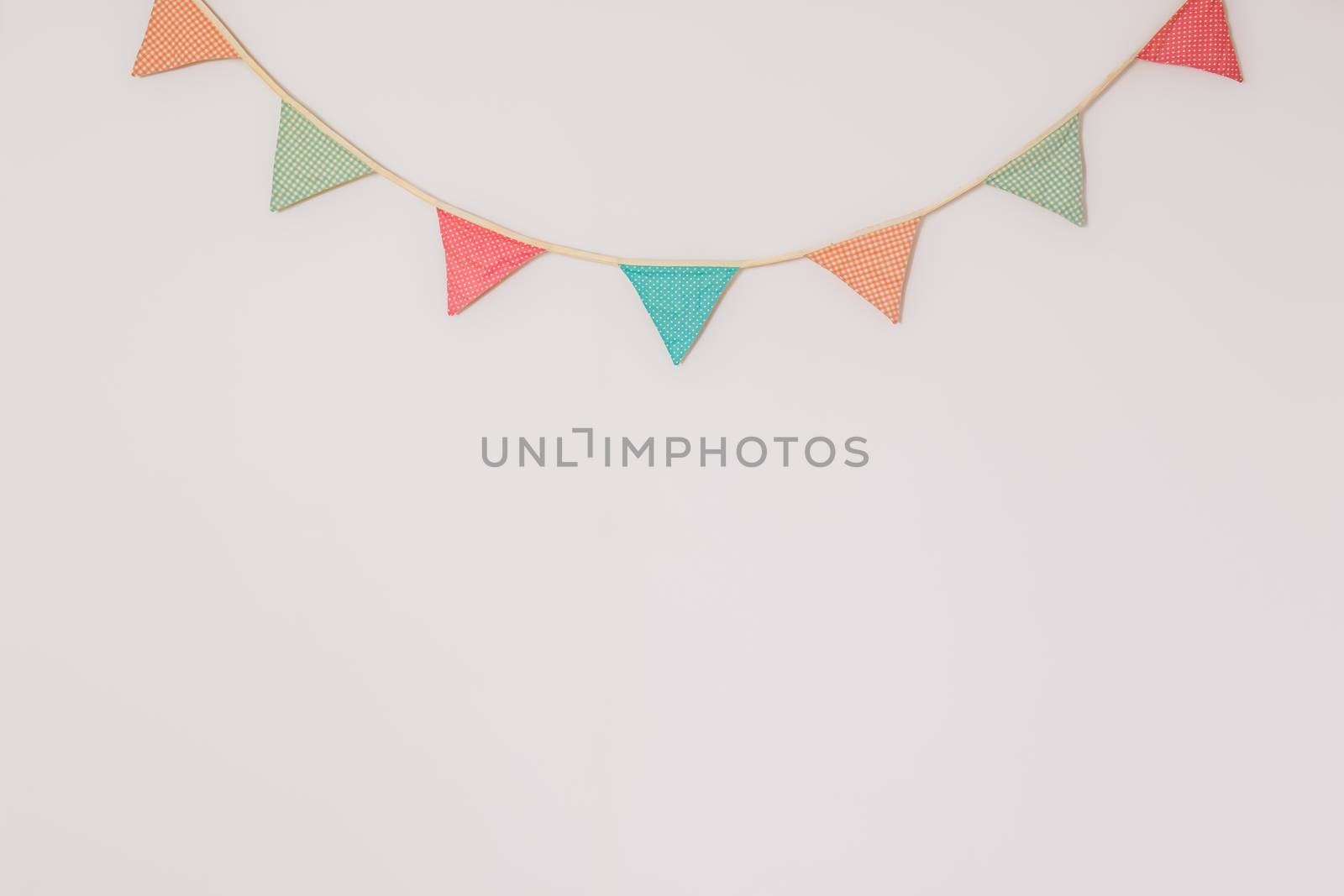 Garland of cute party flags hanging on the wall. by photoboyko