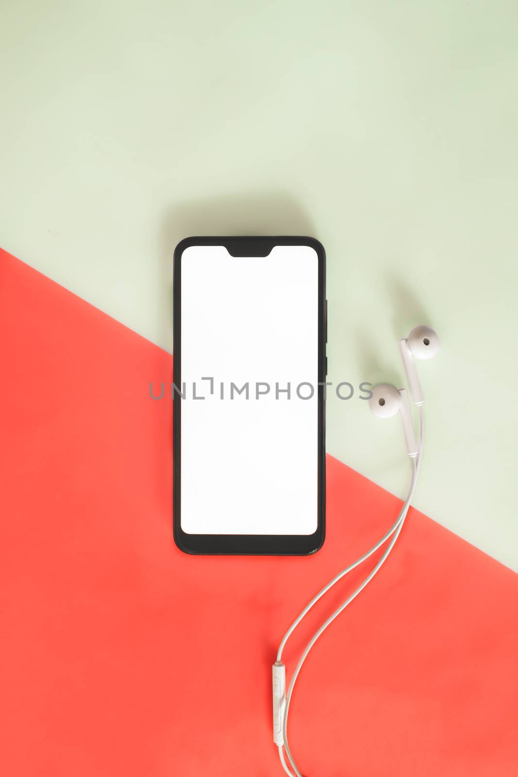 Modern smartphone with white screen and headphones by photoboyko