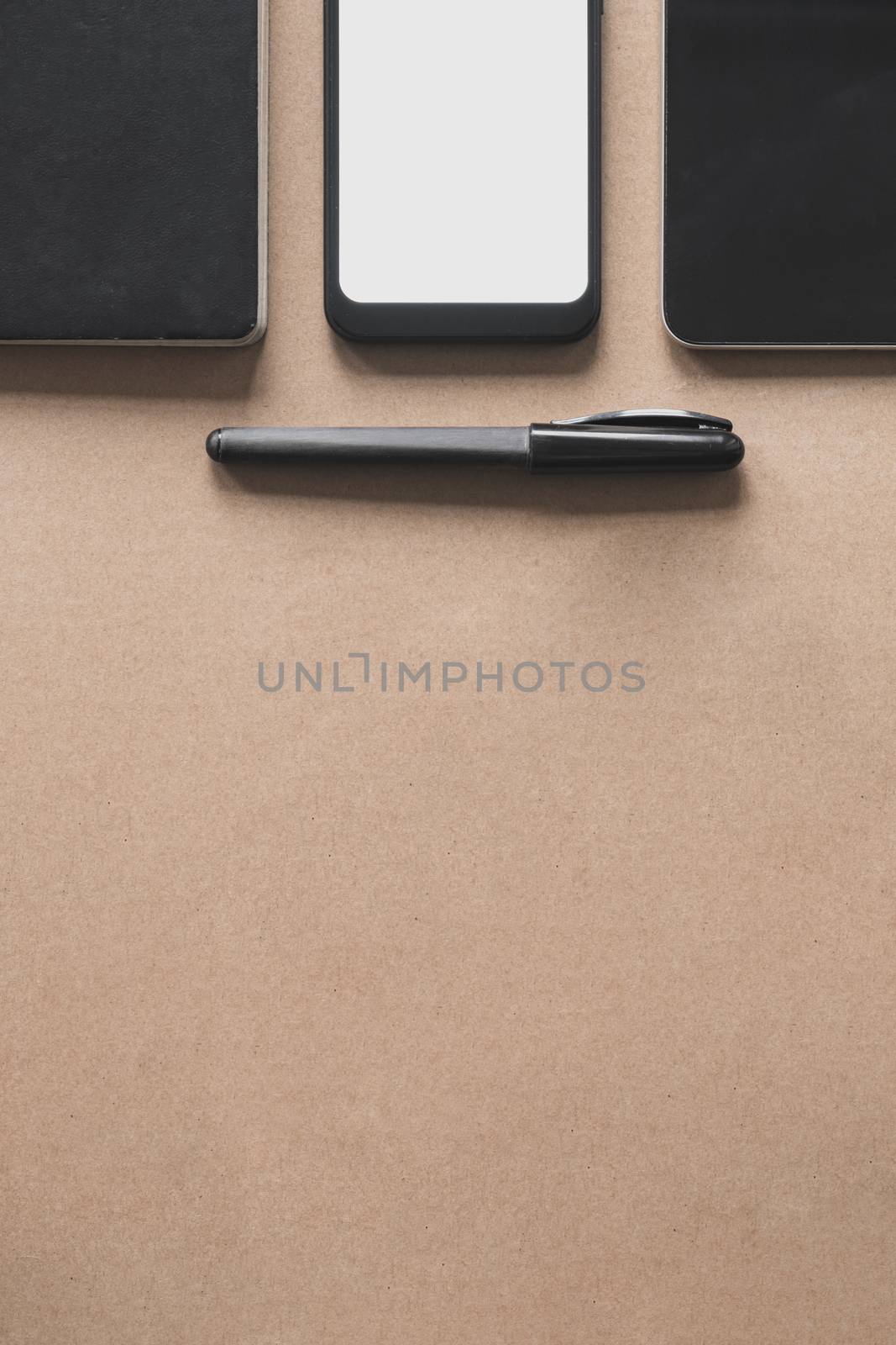 Business flat lay on brown paper background. by photoboyko