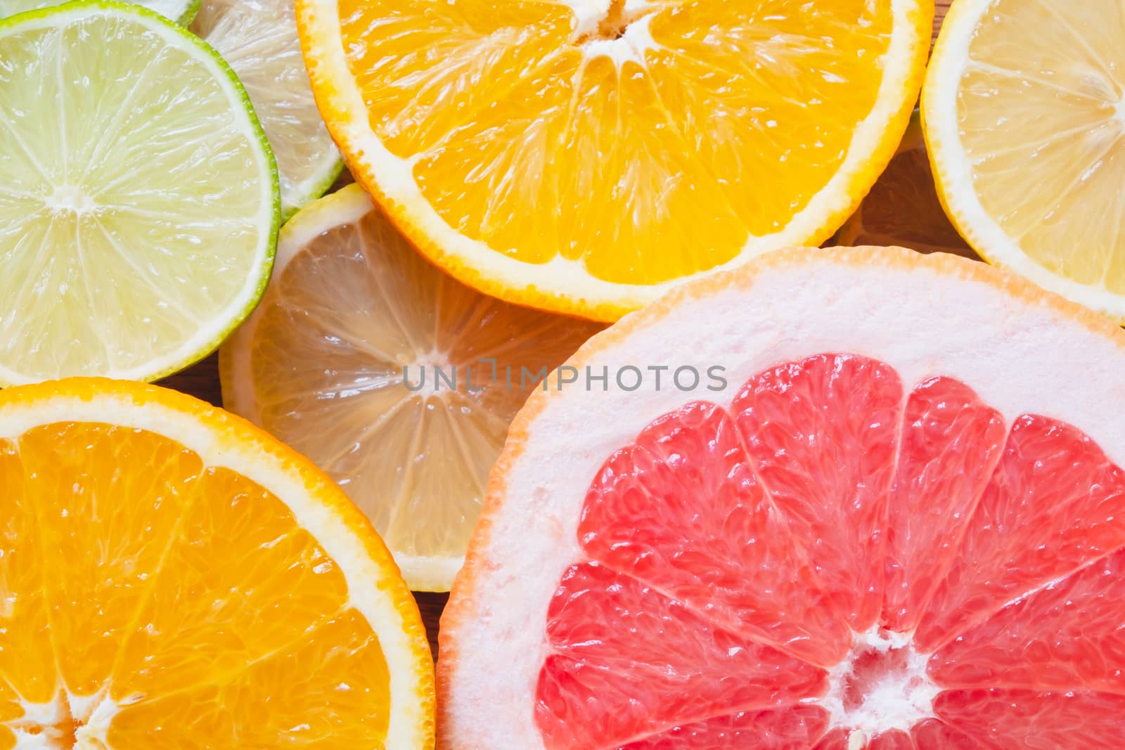 Fresh juicy citrus fruit background. by photoboyko