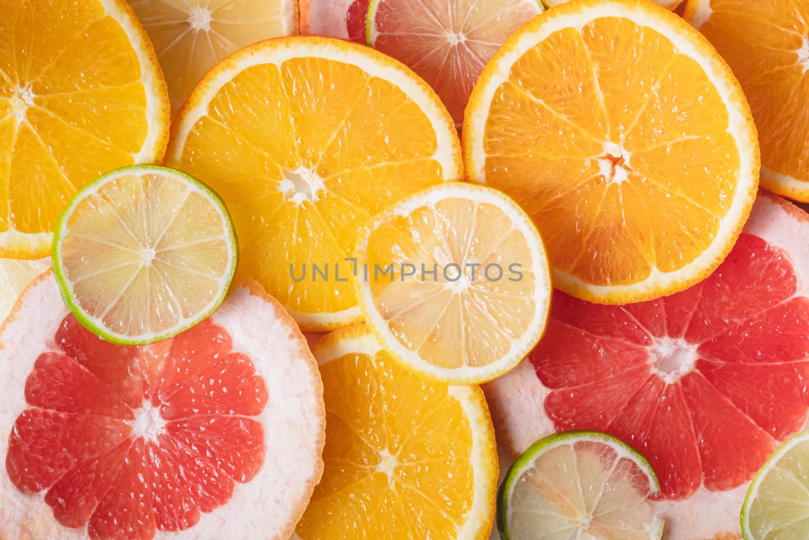 Fresh juicy citrus fruit background. Healthy fresh raw food, lemonade indgredients: orange, lime, grapefruit and lemon slices