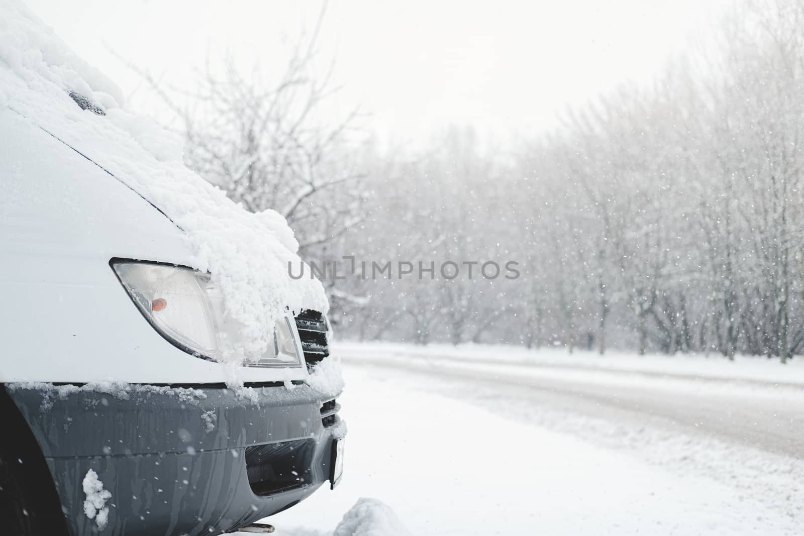 The front part of a car covered in snow. by photoboyko