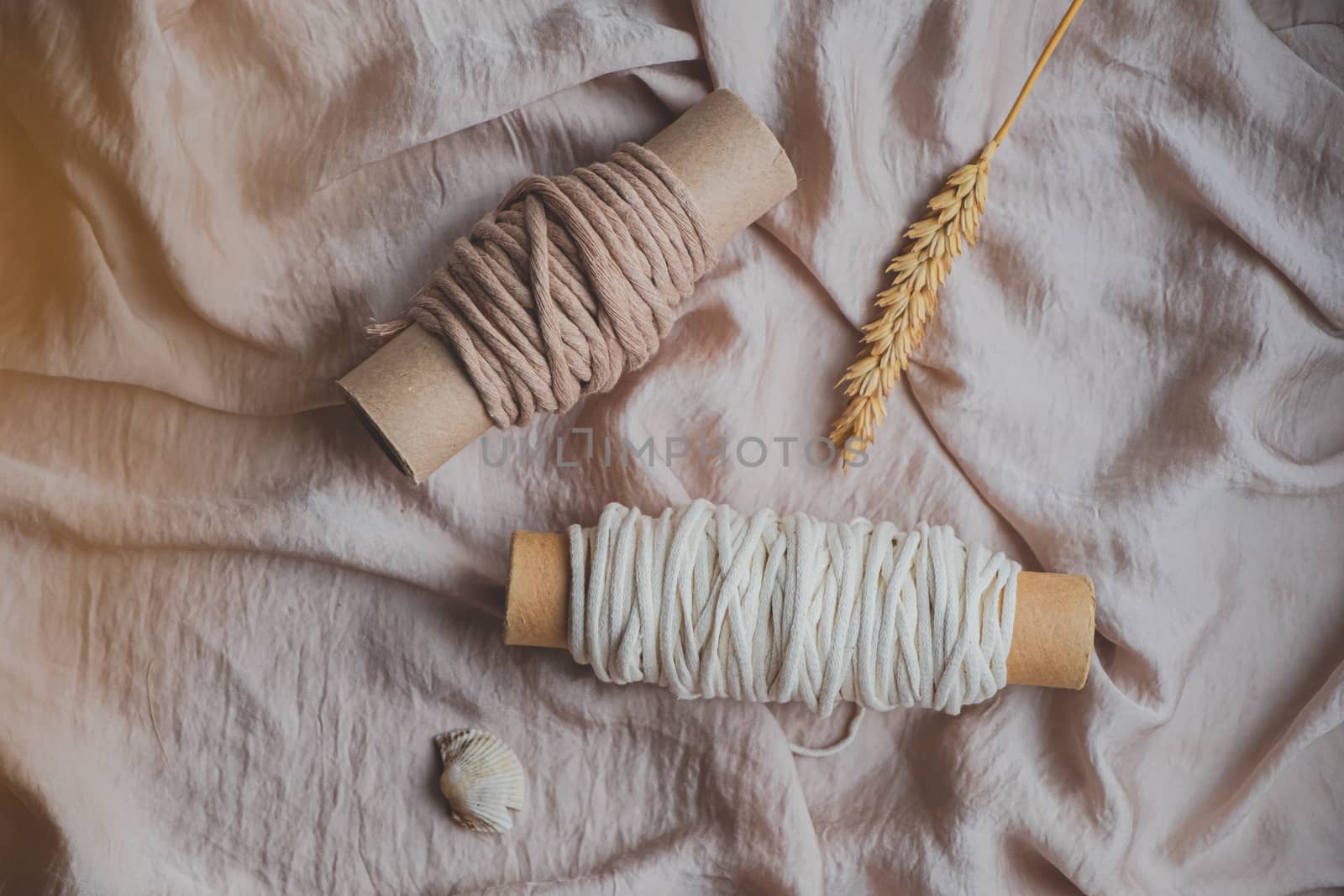 Macrame ropes in pastel colors, top view. Crochet threads in beautiful pastel backdrop, flat lay image