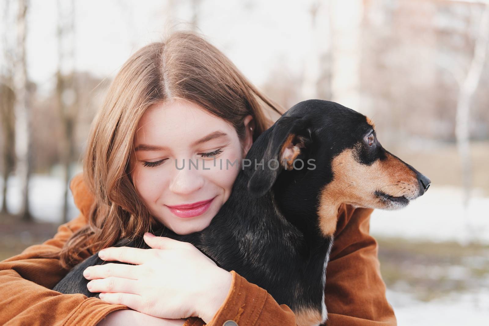 Woman hugs happily with a dog. by photoboyko