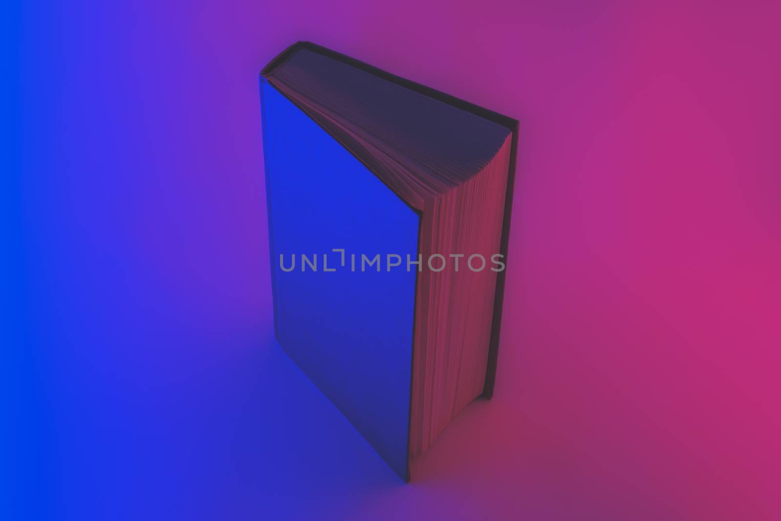 Open book in faded blue and red colors. Neon gradients, abstract background image of a book