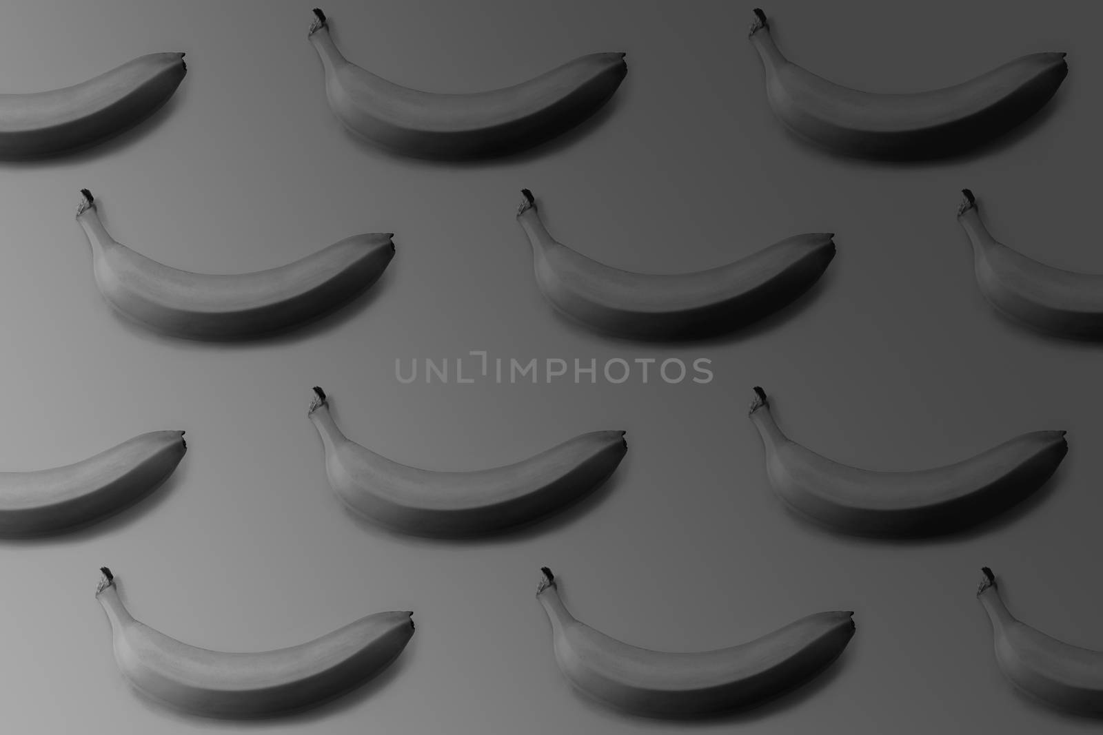 Banana pattern on dark backdrop, monochrome image. by photoboyko