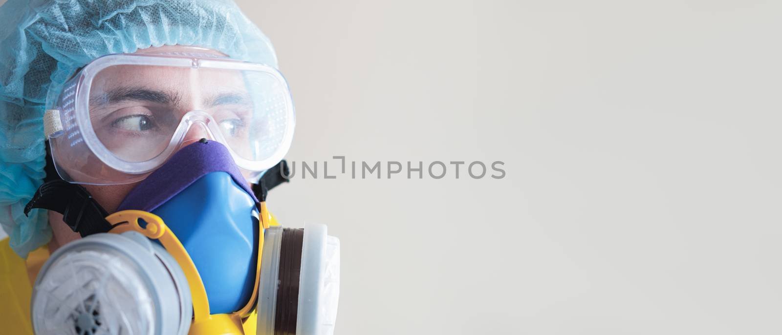 Man in protective face mask and eyeglasses, copy space . Medical personell, scientist or MD in work gear, concept of covid-19, virus, epidemic and vaccine development