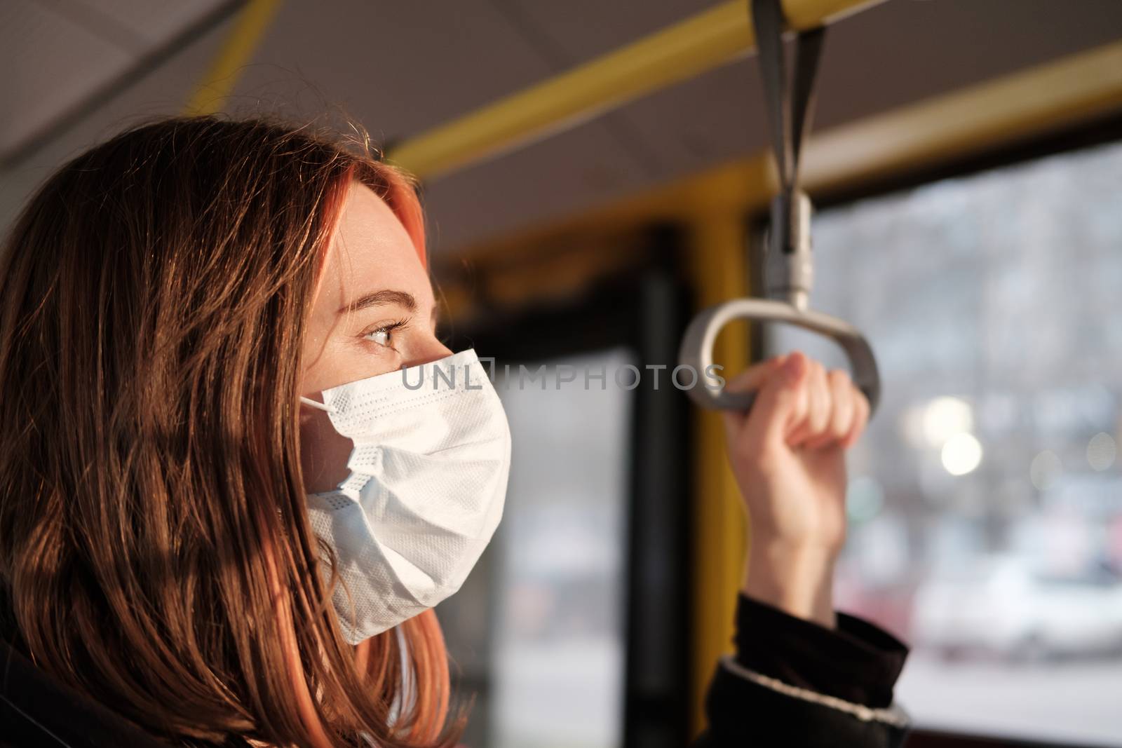 Commuter wears a protective mask in public transport. Coronavirus, COVID-19 spread prevention concept, responsible social behaviour of a citizen