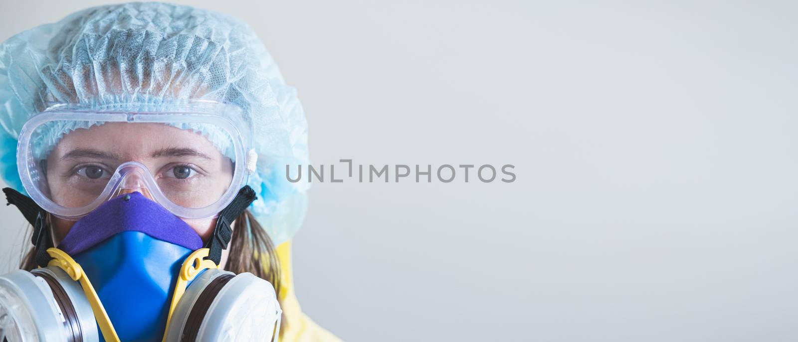 Portrait of a healthcare worker woman in protective gear by photoboyko