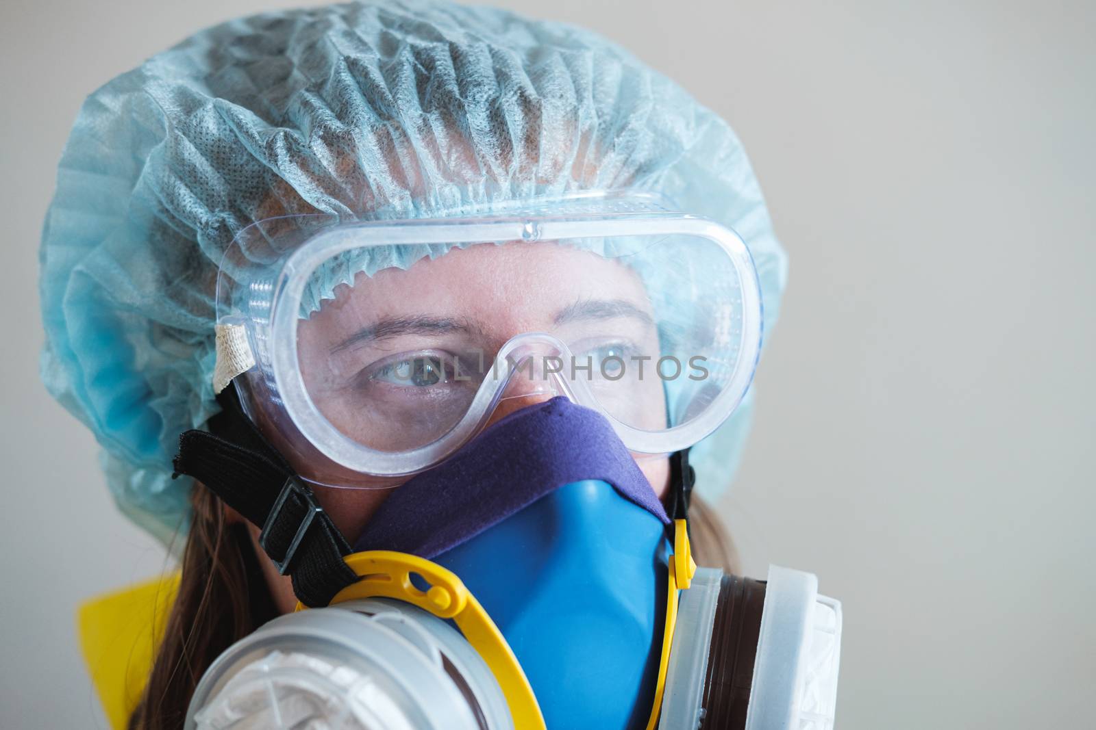 Portrait of a healthcare worker woman in protective glasses and respirator mask. Medical staff, hospital doctor or scientist developing anti virus vaccine.