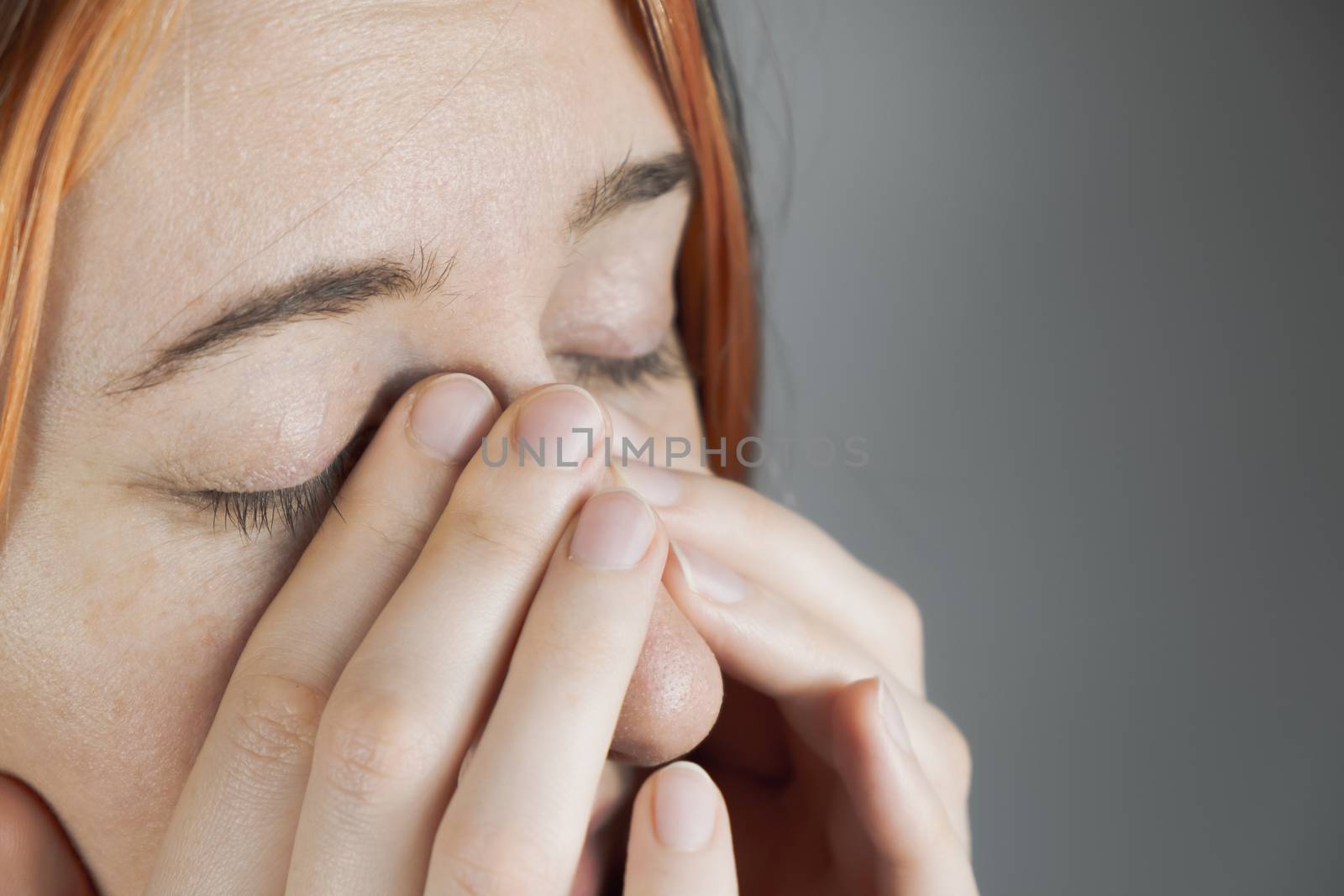 Touching eyes with fingers - concept of bringing virus or infection. Woman covers nose with hands trying to sneeze, personal hygiene or health care