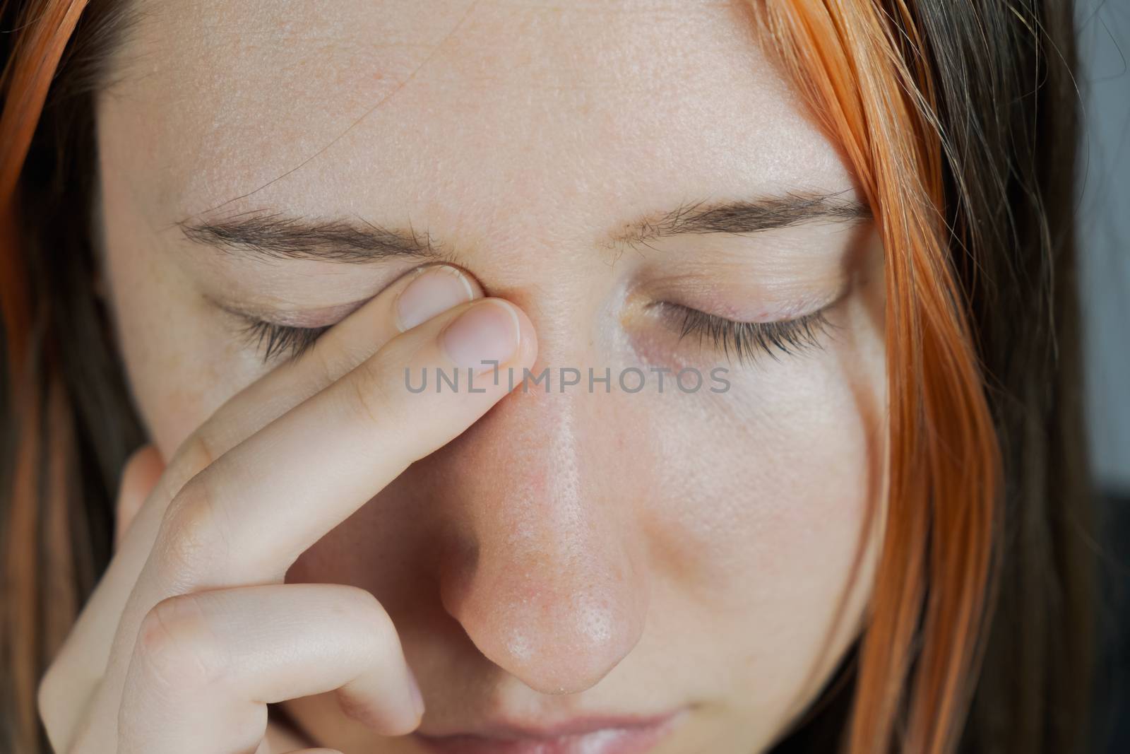 Touching face with hands, concept of bringing infection to eyes. by photoboyko