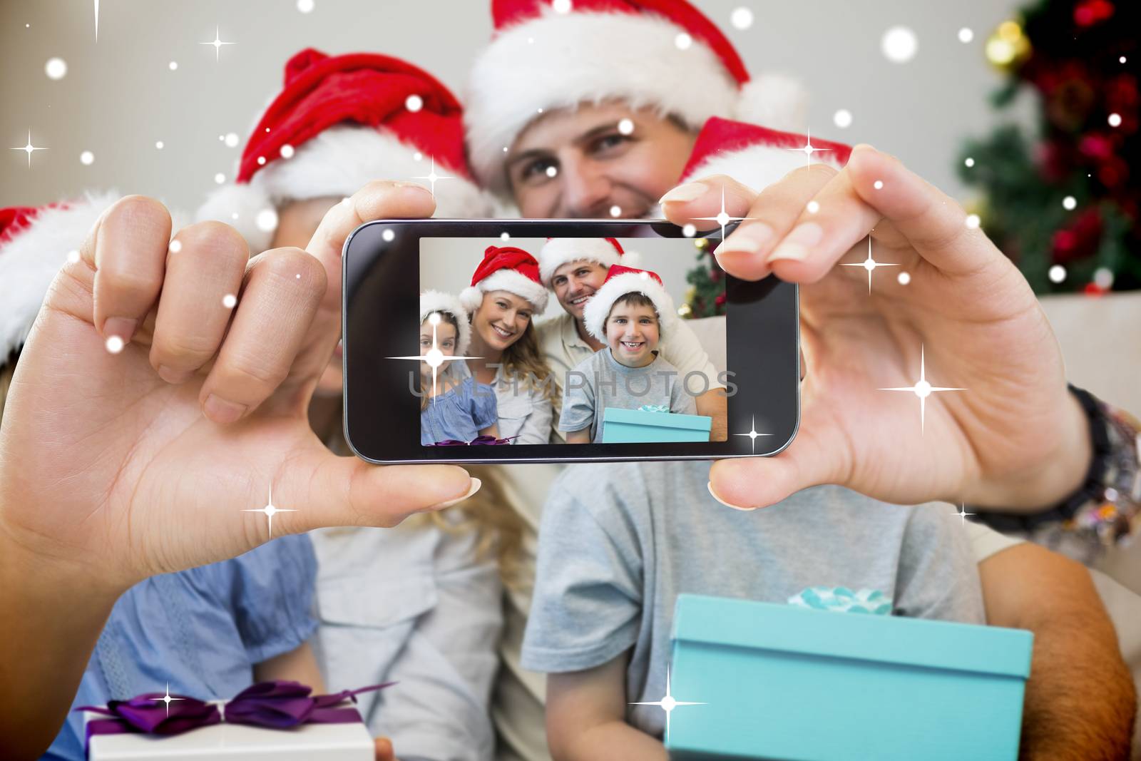 Hand holding smartphone showing photo against snow