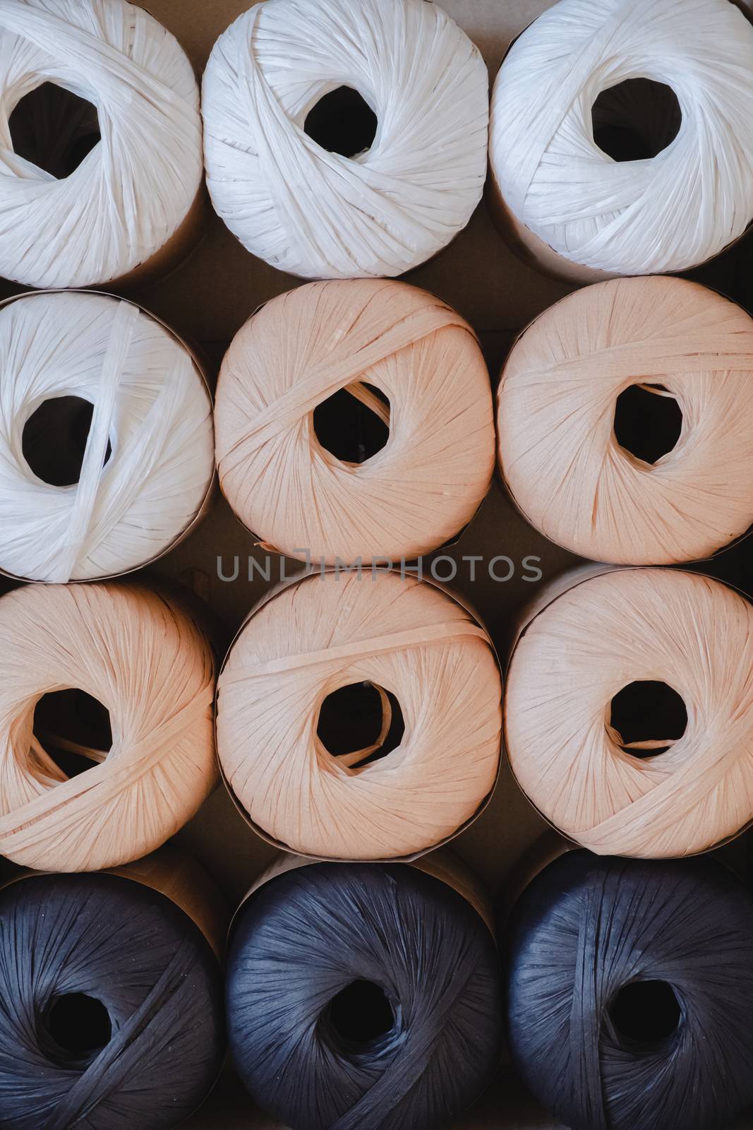 Rolls of raffia threads, top view. by photoboyko