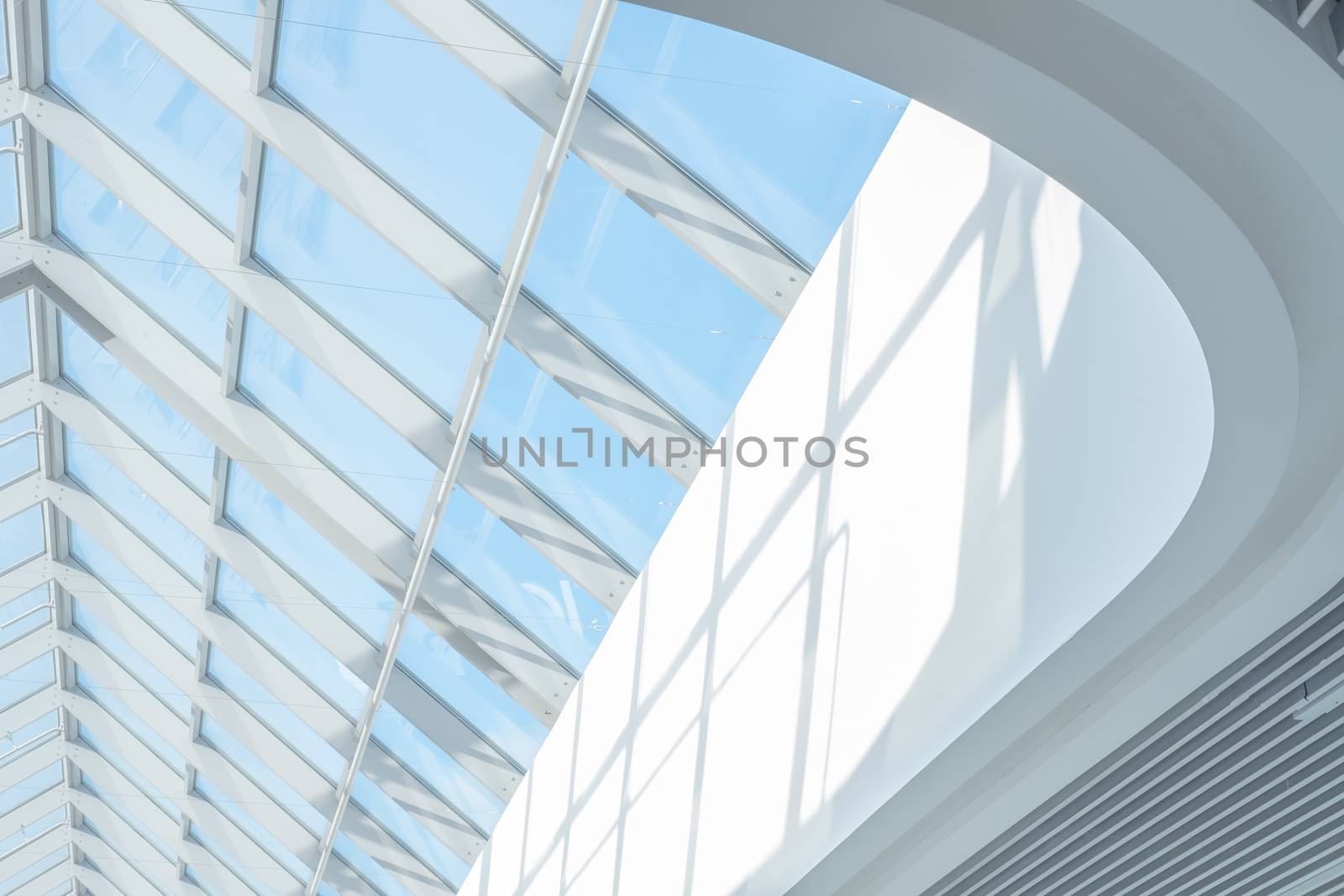 Clean roof windows and blue sky. Element of a modern glass roof of a shopping mall or airport, abstract image