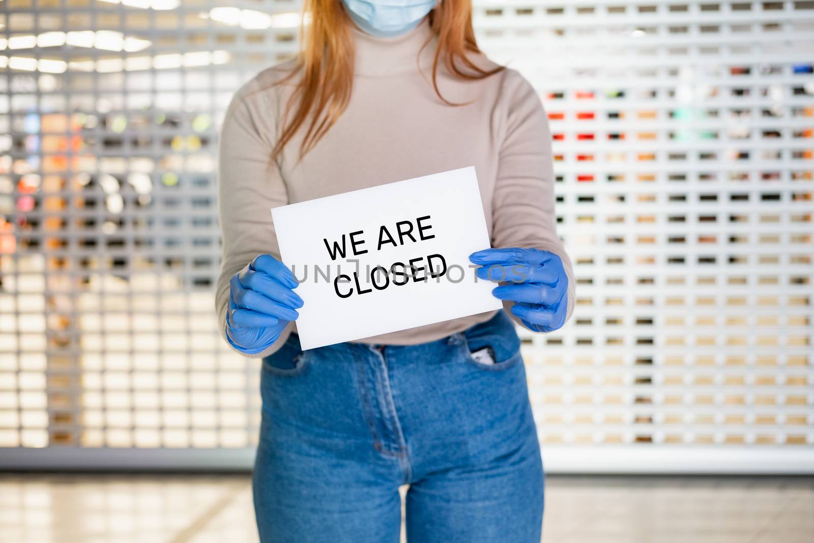 "We are closed" sign in woman's hands. by photoboyko