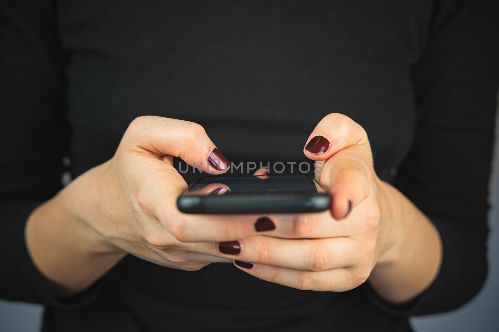 Texting on the phone, using smartphone. by photoboyko