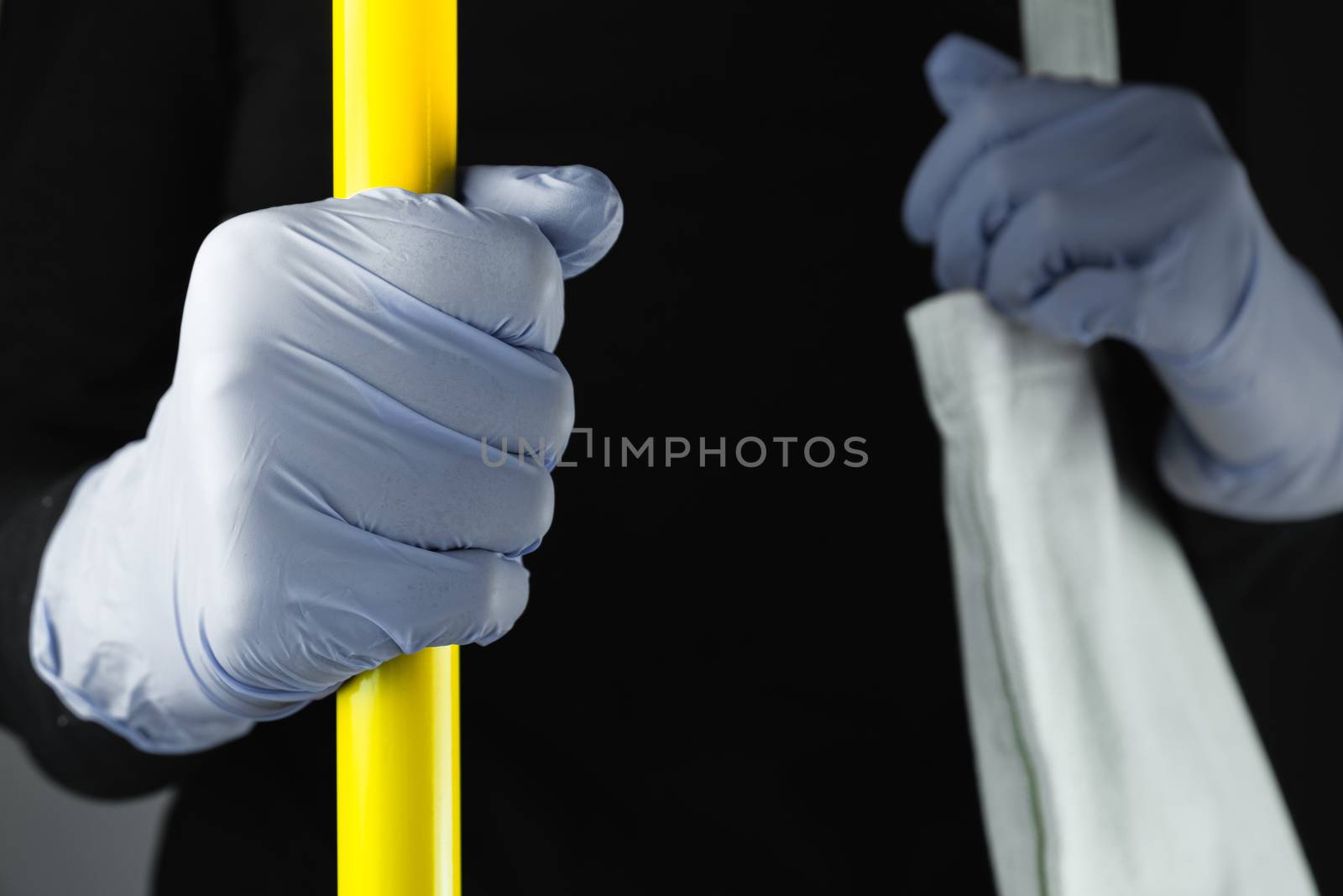 Hand in protective glove holding handlebar in public transport.  by photoboyko
