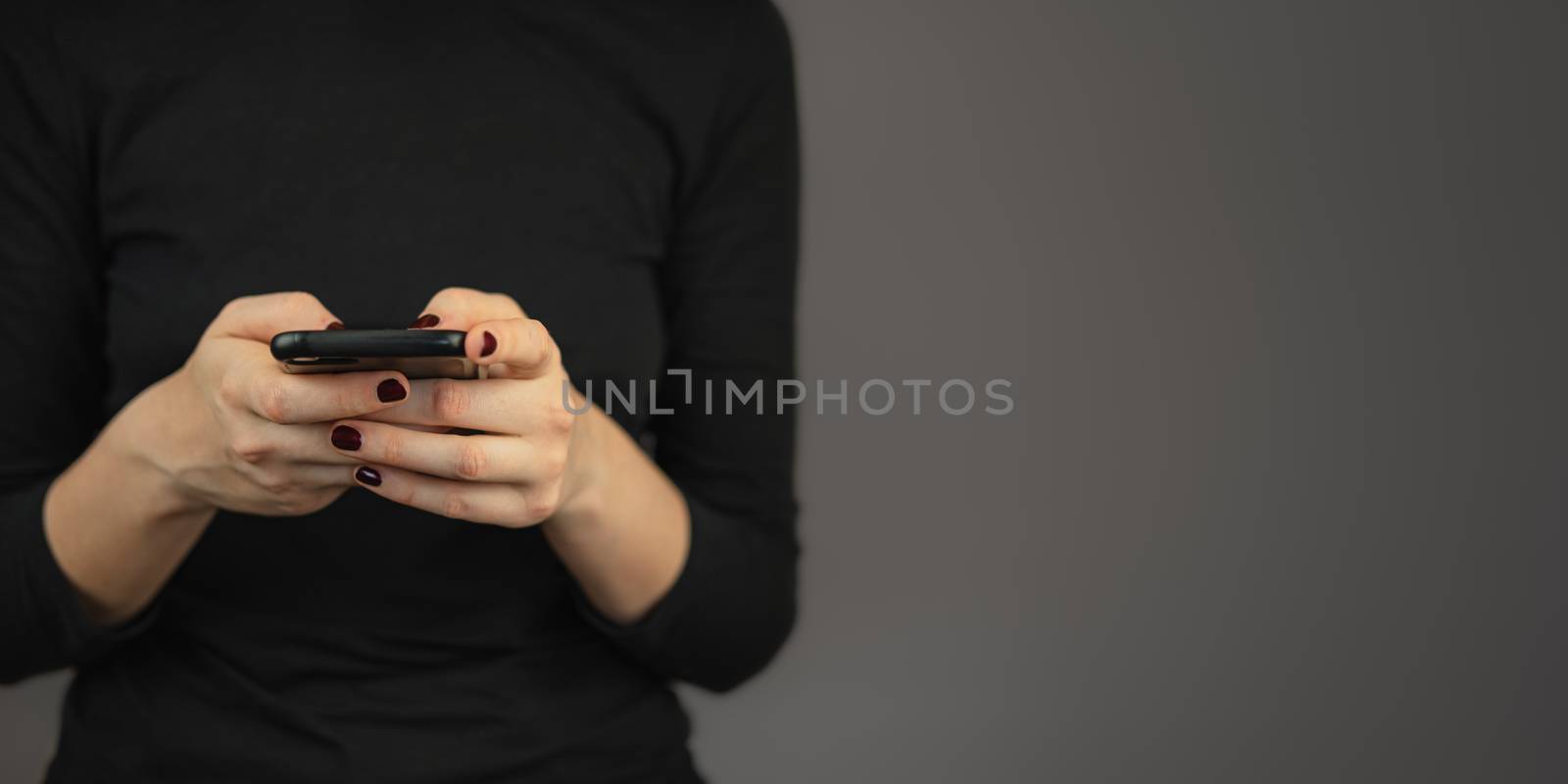 Texting on the phone, using smartphone, copy space backdrop by photoboyko