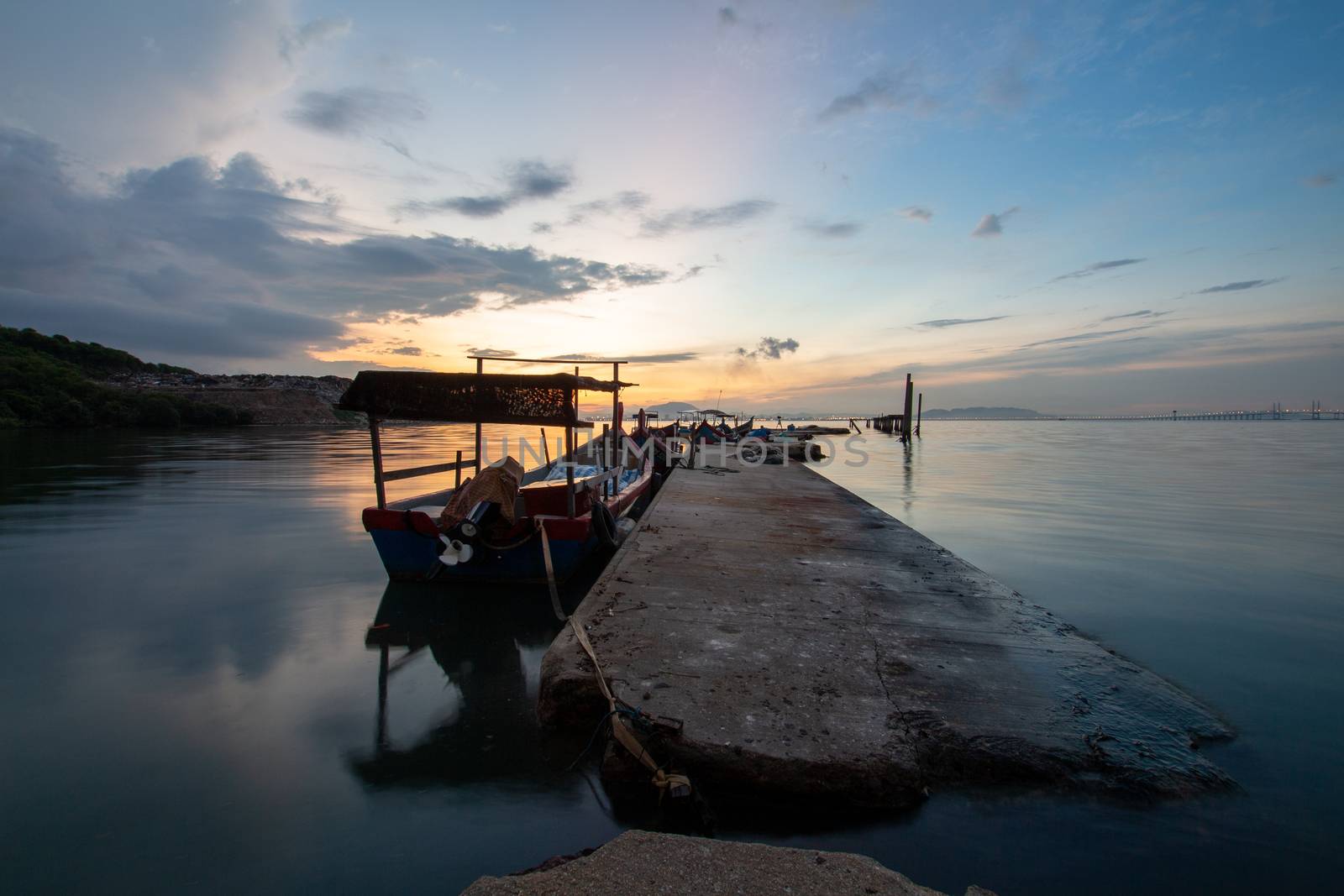 Cement fisherman jetty Jelutong, Penang, Malaysia during sunrise.