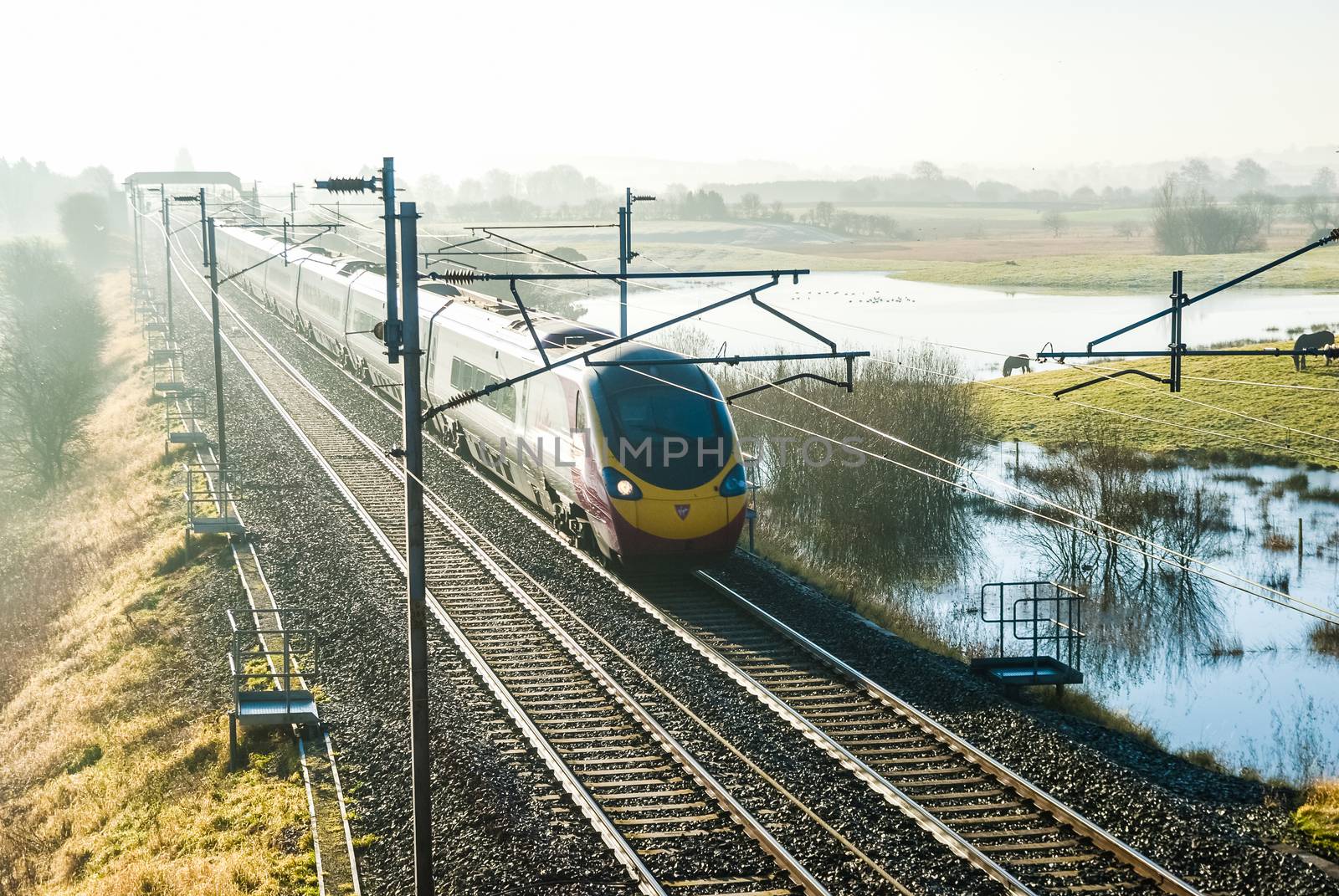 Virgin Train Express passenger train in the countryside UK