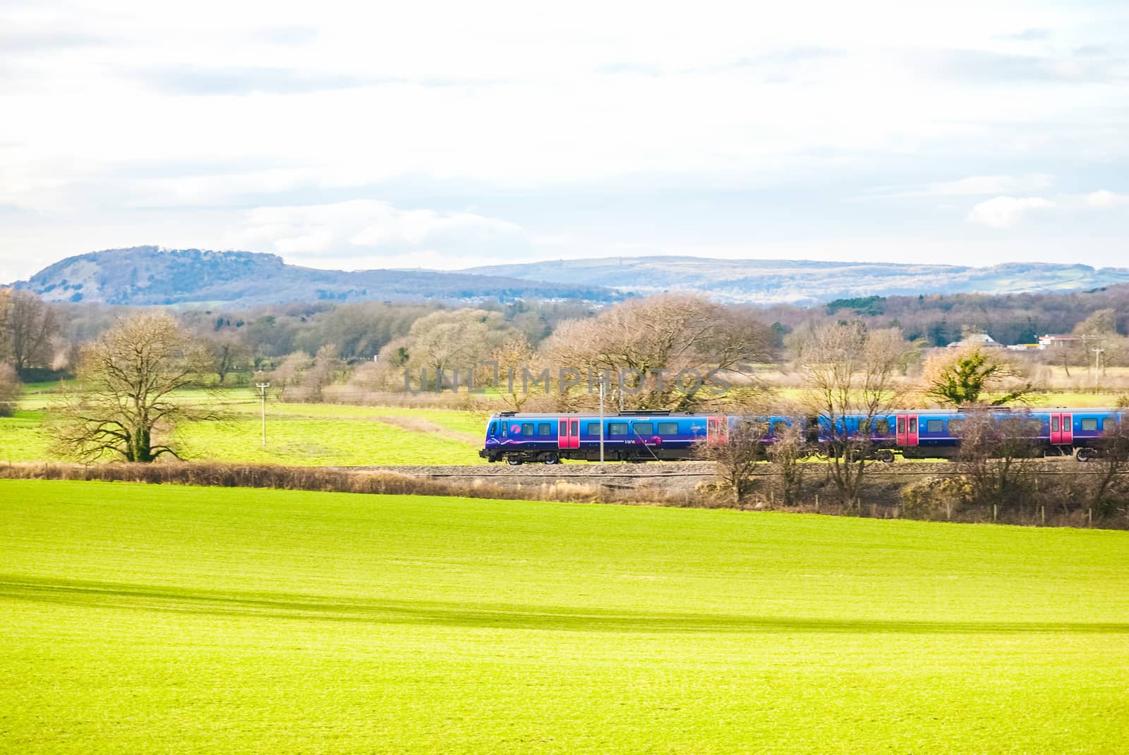 A TransPennine Express passenger train in the countryside UK by paddythegolfer