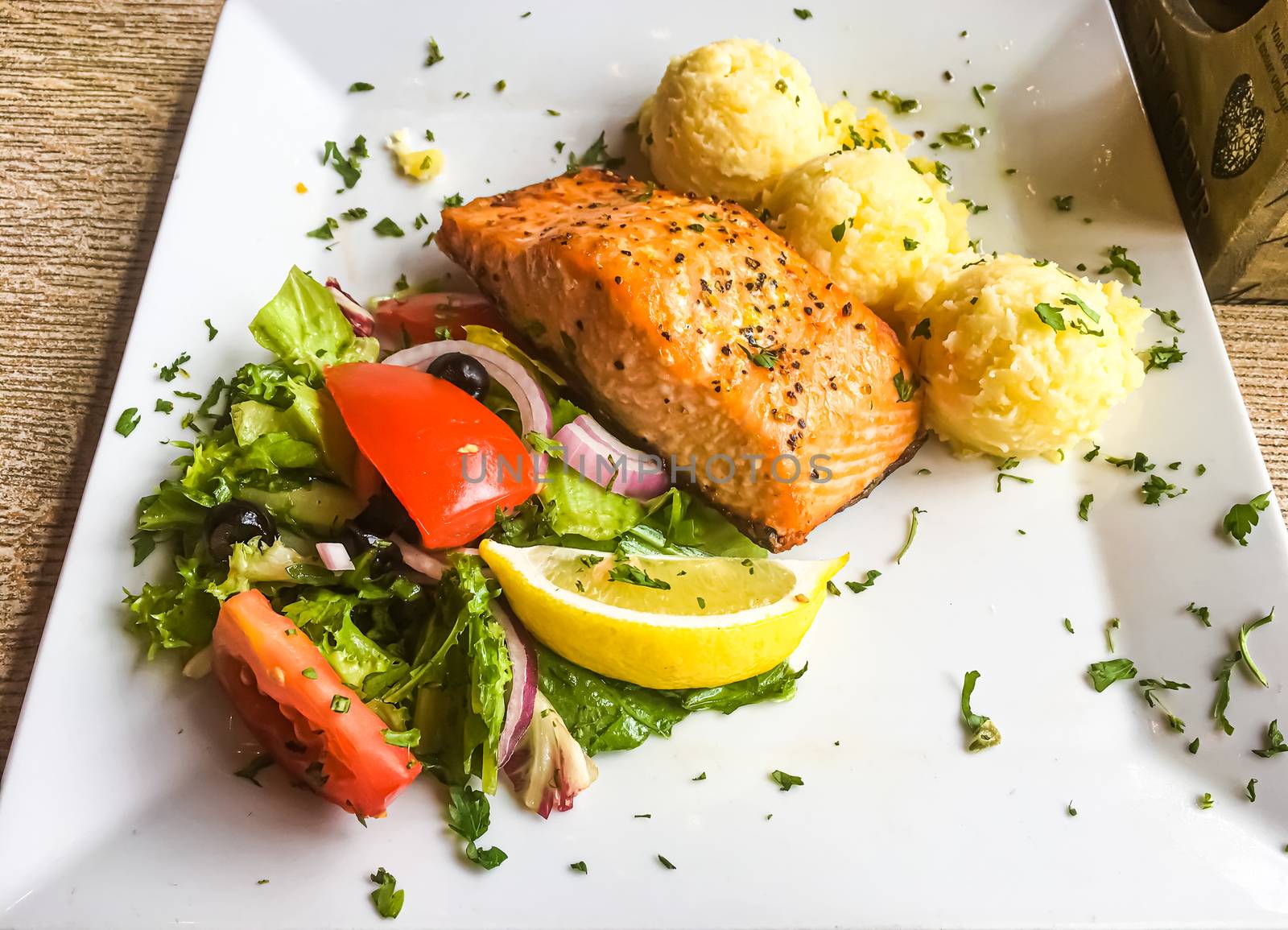 Grilled salmon, mashed potatoes and salad for lunch, served meal