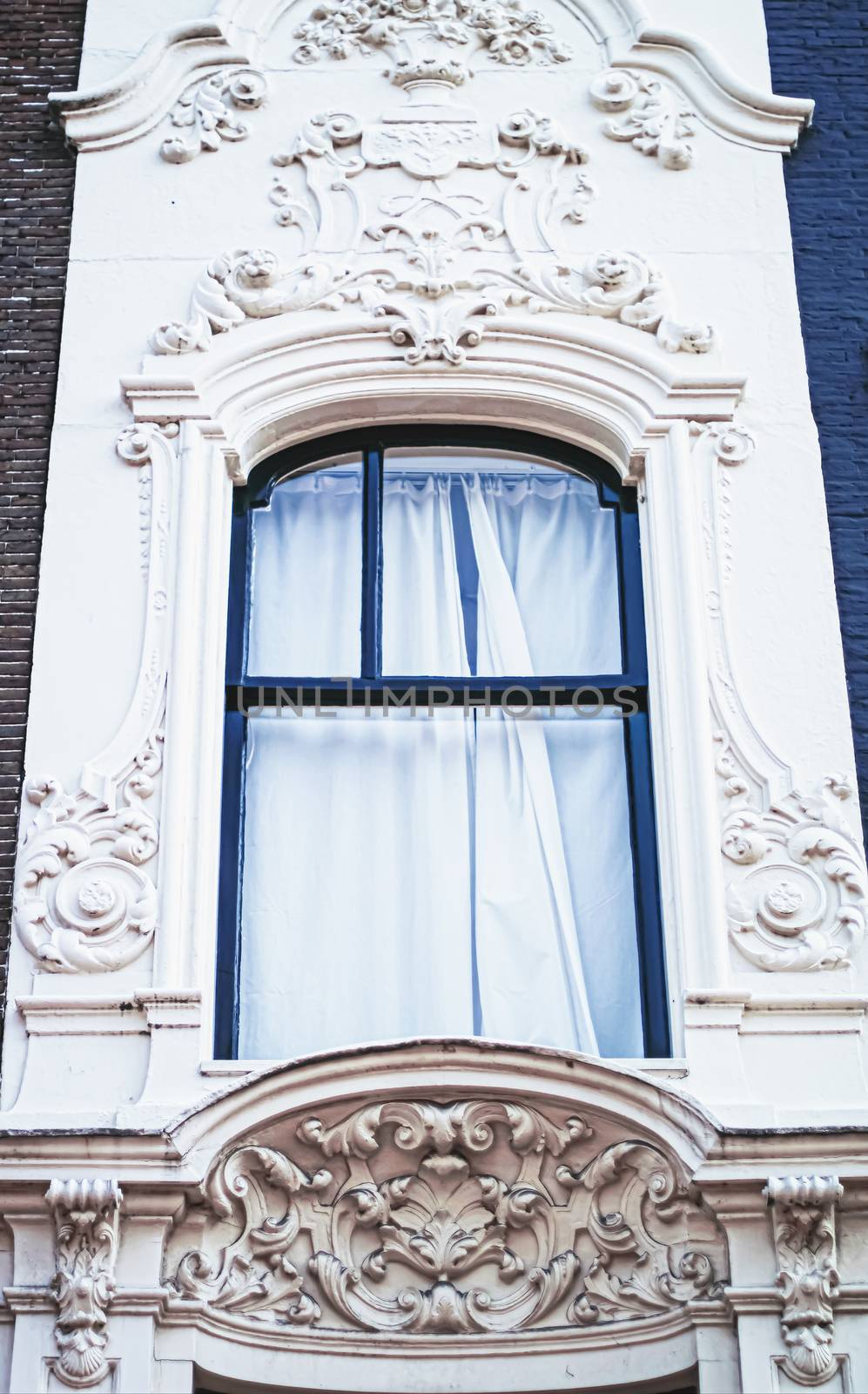 Architectural detail of a building on the main city center street of Amsterdam in Netherlands, european architecture
