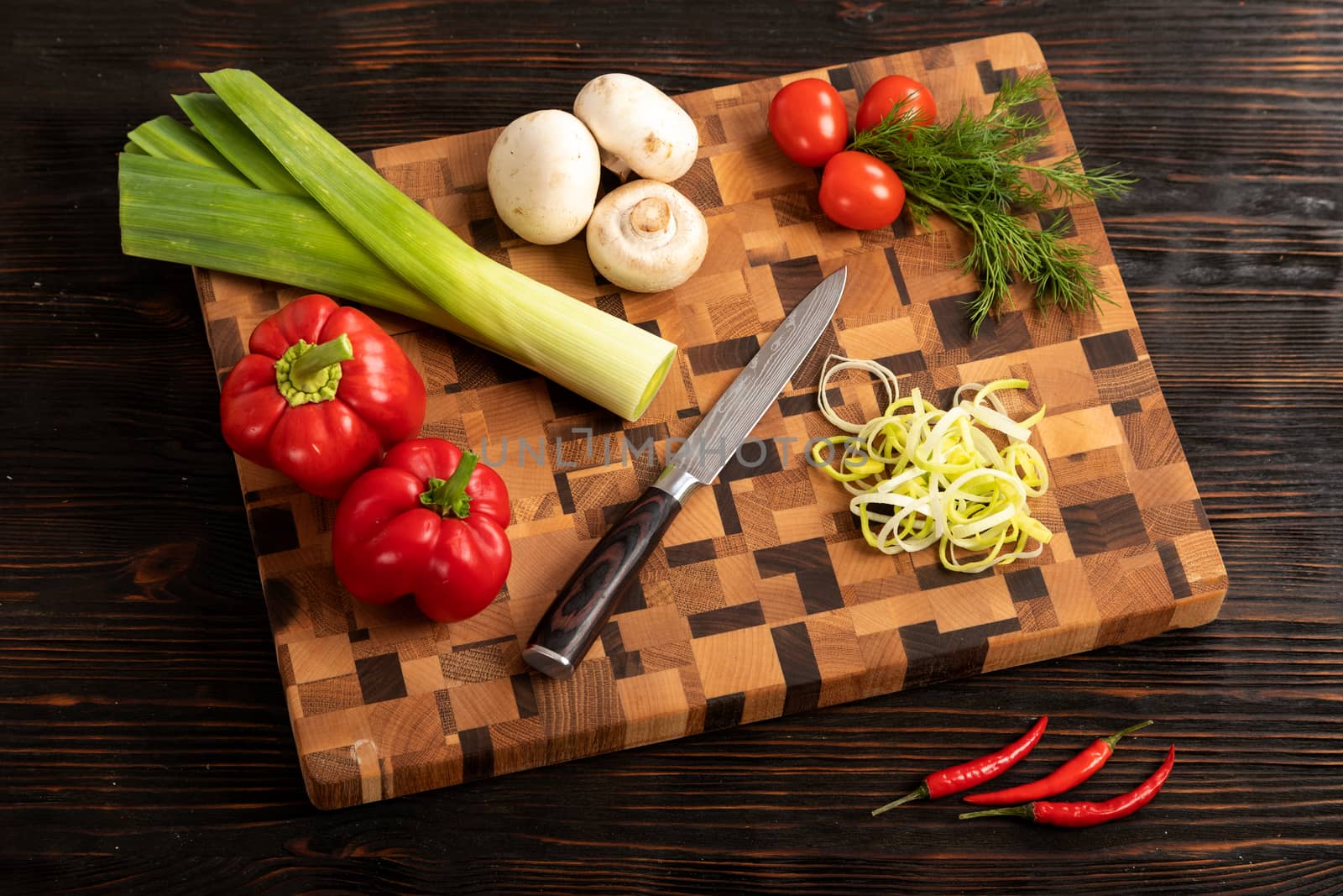 vegetables and spices on a wooden cutting board by sveter