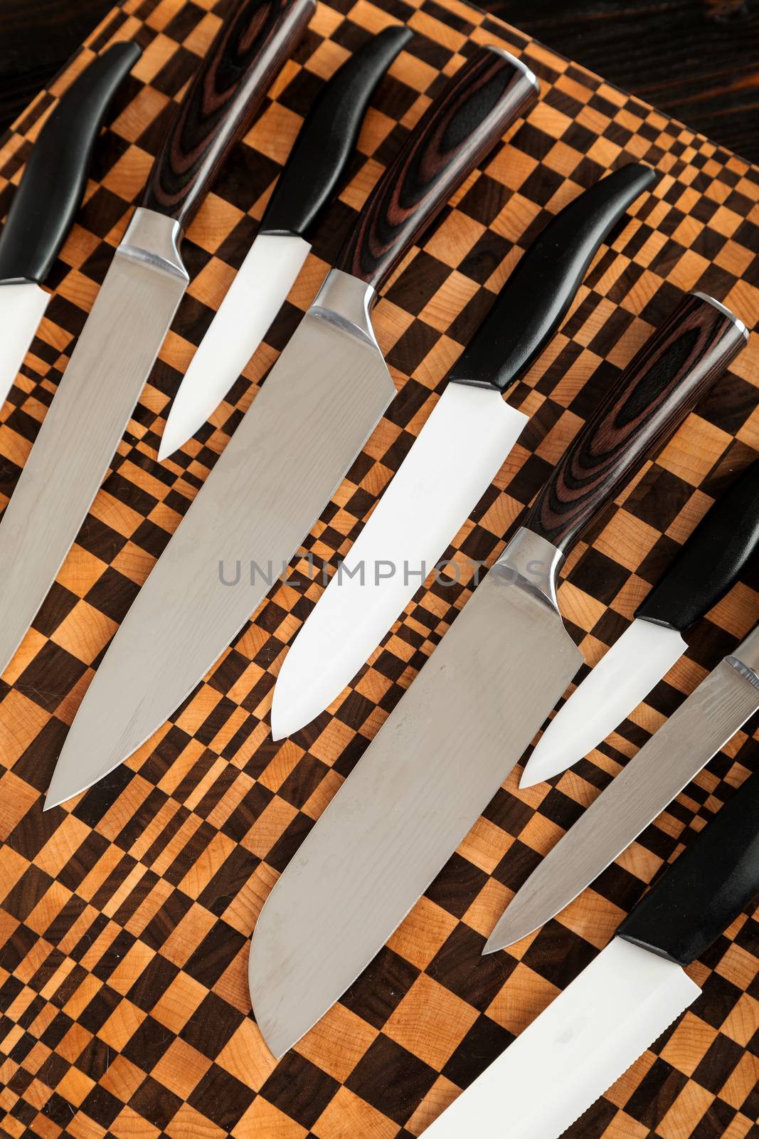 A set of high quality kitchen knives on a wooden cutting board