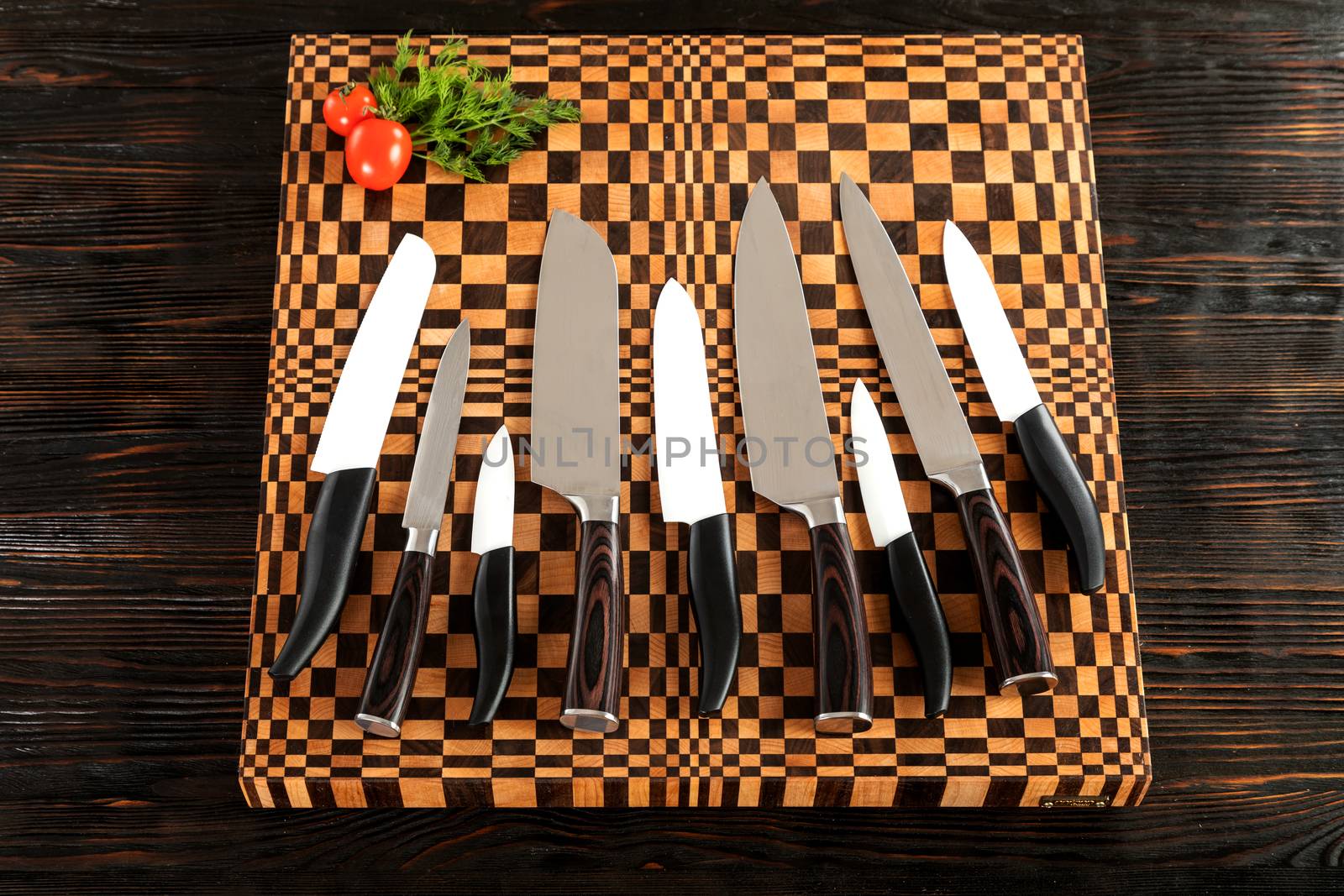 A set of high quality kitchen knives on a cutting board by sveter