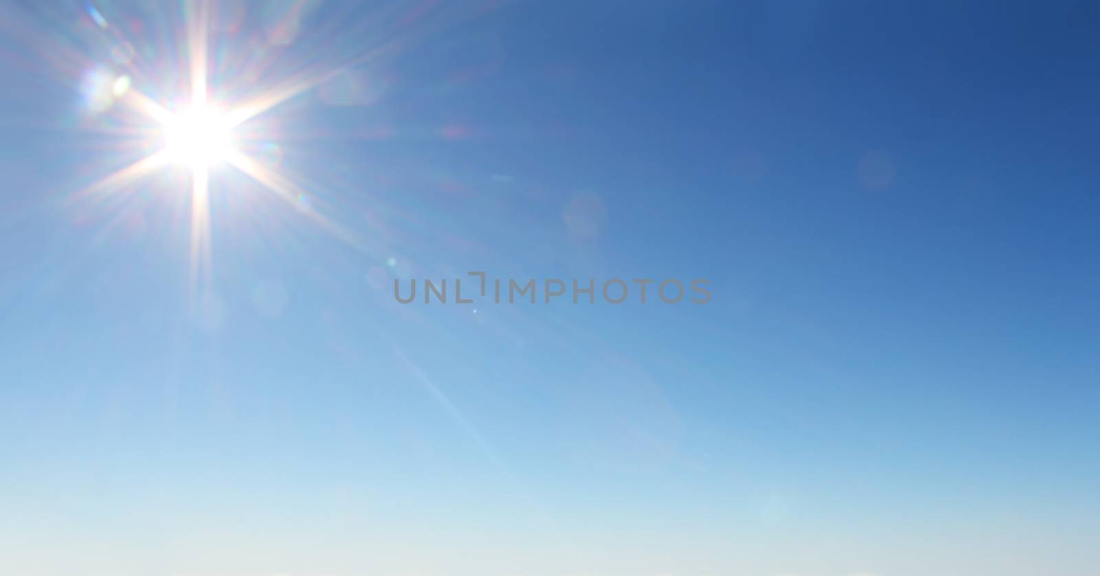 Shining sun at clear blue sky with copy space with copy space