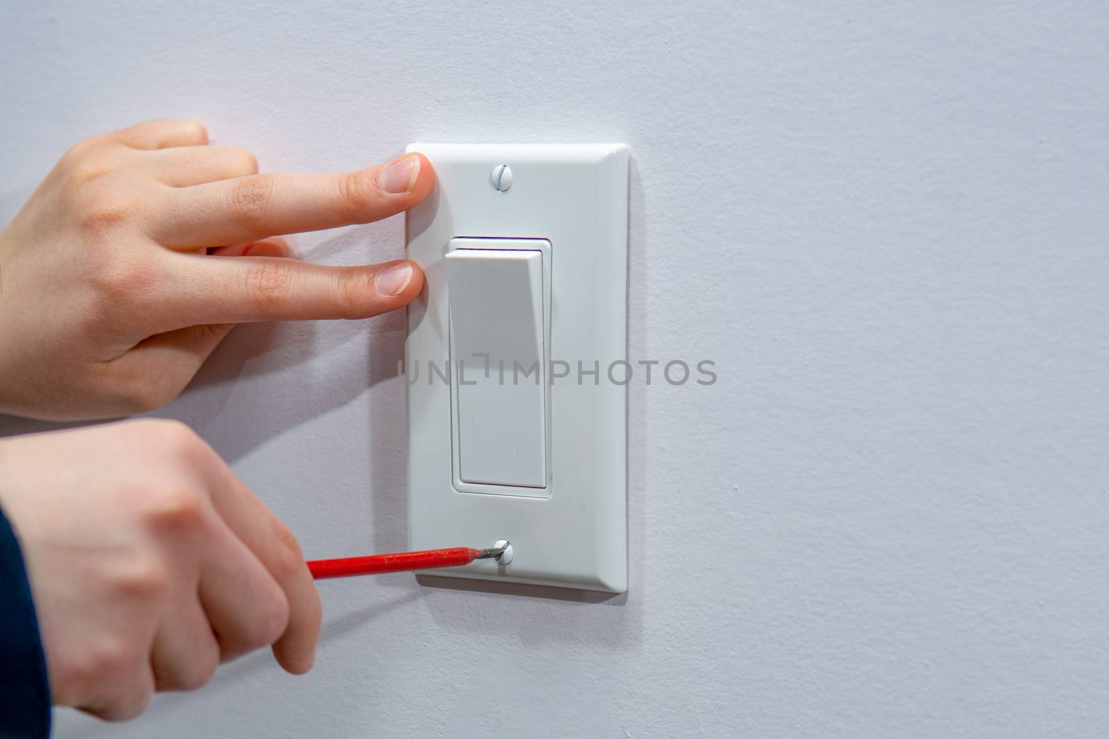 Attaching a white platband to an electric wall switch