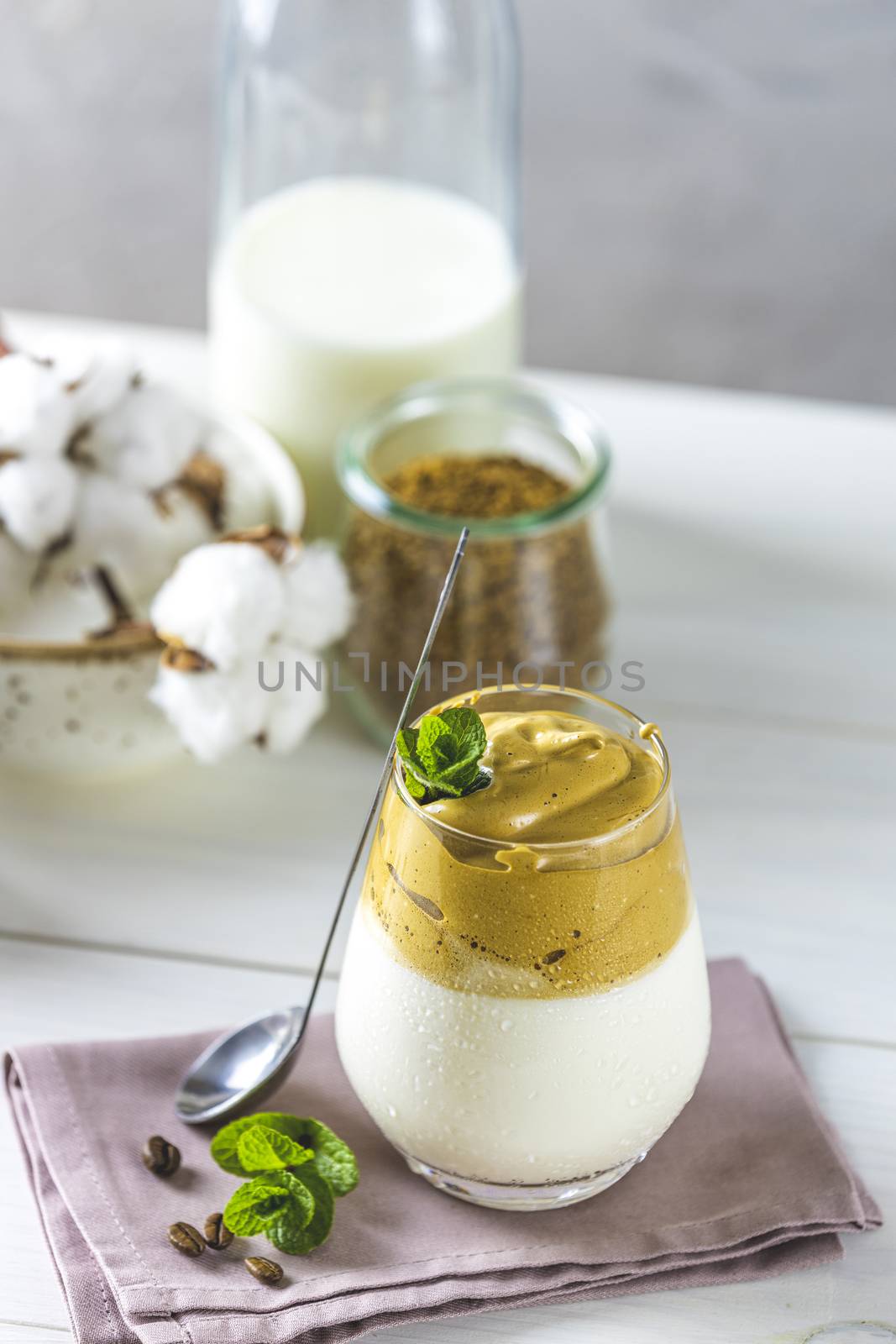 Glass of Iced Dalgona Coffee, a trendy fluffy creamy coffee by ArtSvitlyna