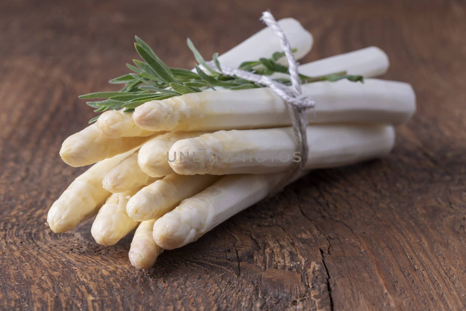 bunch of white asparagus on wood by bernjuer