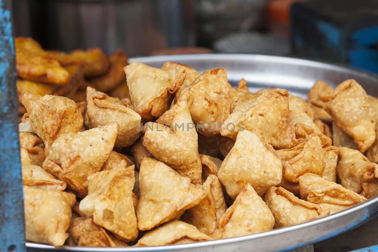 lots of indian samosa on a plate by bernjuer