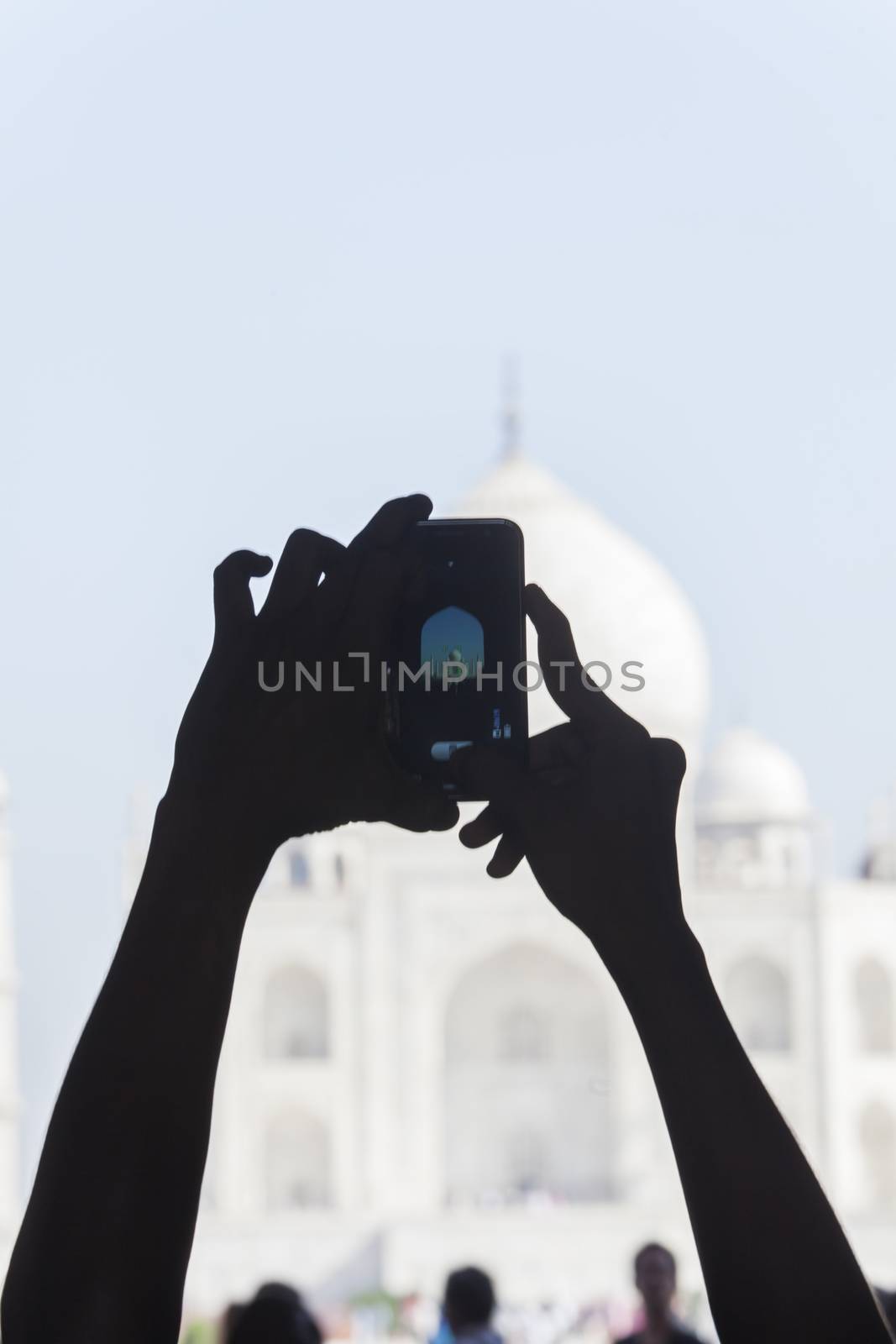 hands photographing the taj mahal