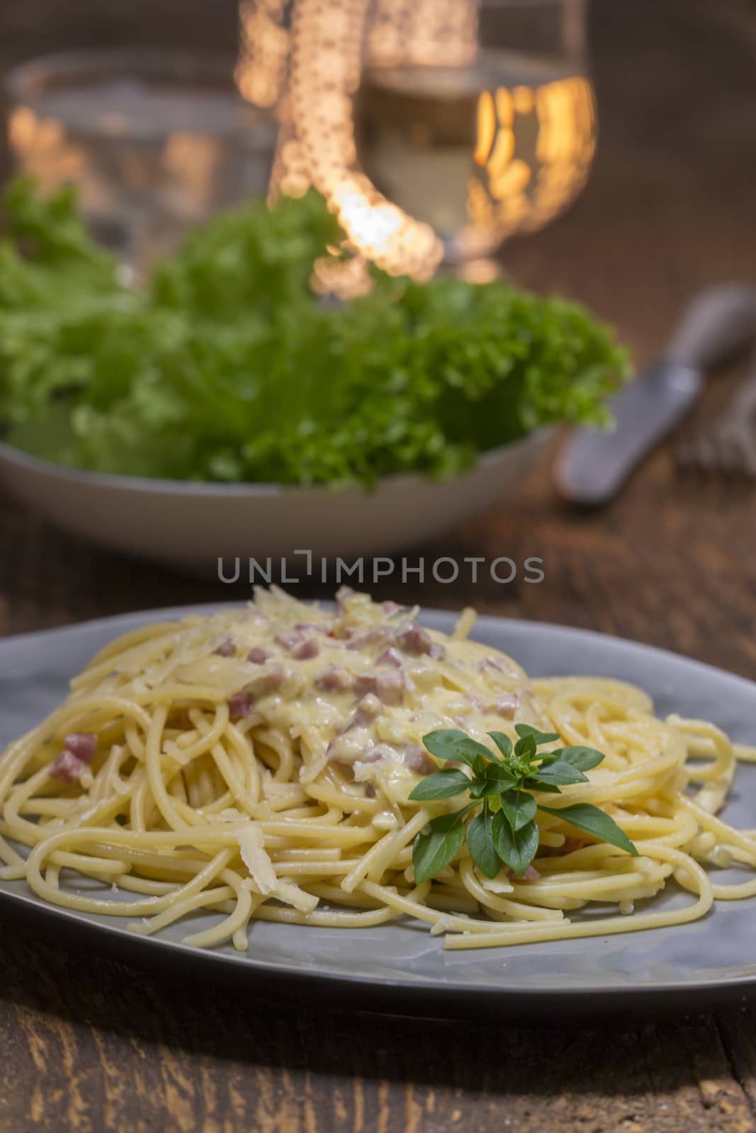 spaghetti carbonara on a white plate by bernjuer