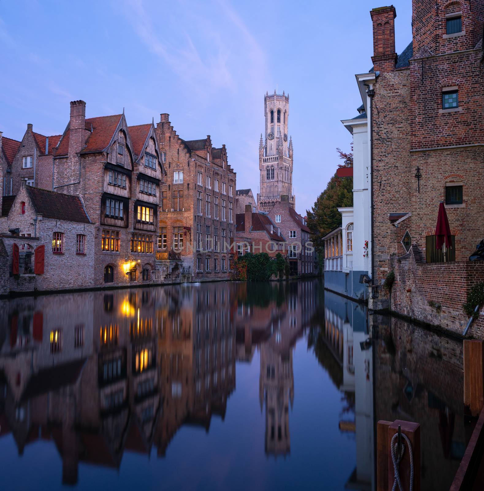 Early morning mood an the channels of Bruges with old buildings reflecting in the water, Belgium