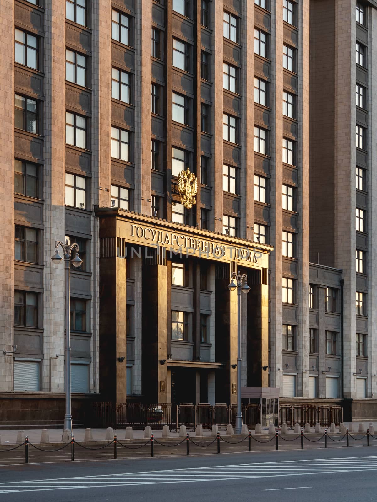 Building of State Duma of Russia inscribed - State Parliament . Deserted Okhotny Ryad street. Moscow, Russia. by aksenovko