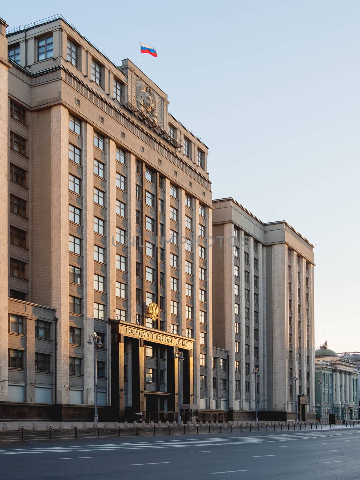 Building of State Duma of Russia inscribed - State Parliament . Deserted Okhotny Ryad street. Moscow, Russia. by aksenovko