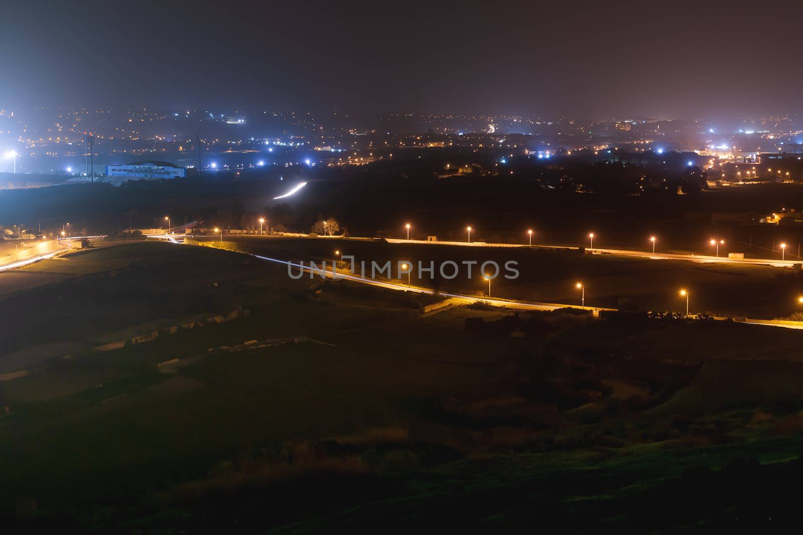 Night panorama view of illuminated roads and grounds around Mdina - old capital of Malta. Shooted with long exposure. by aksenovko